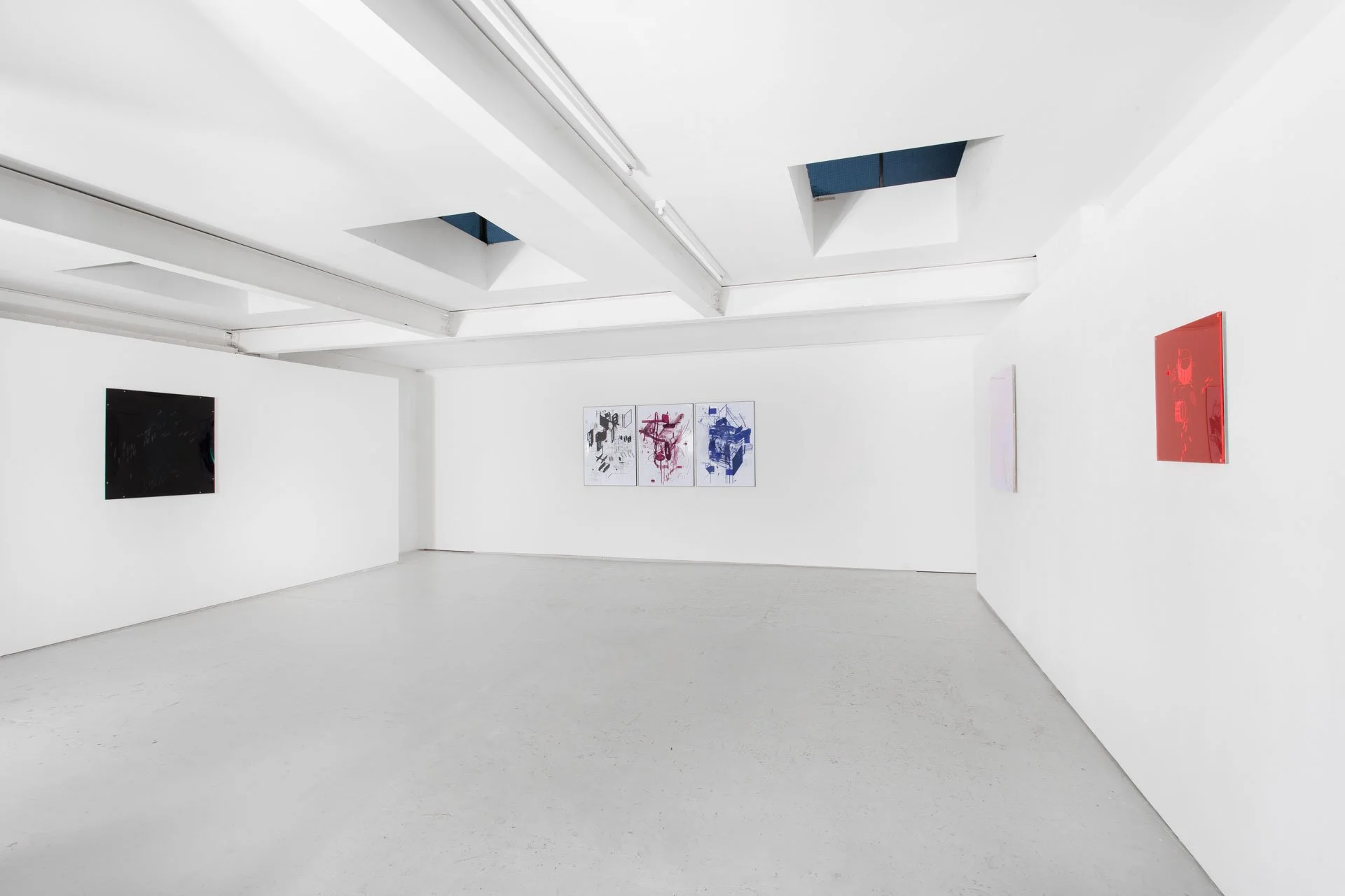 Art gallery with white walls displaying various abstract paintings in black, pink, blue, and red.