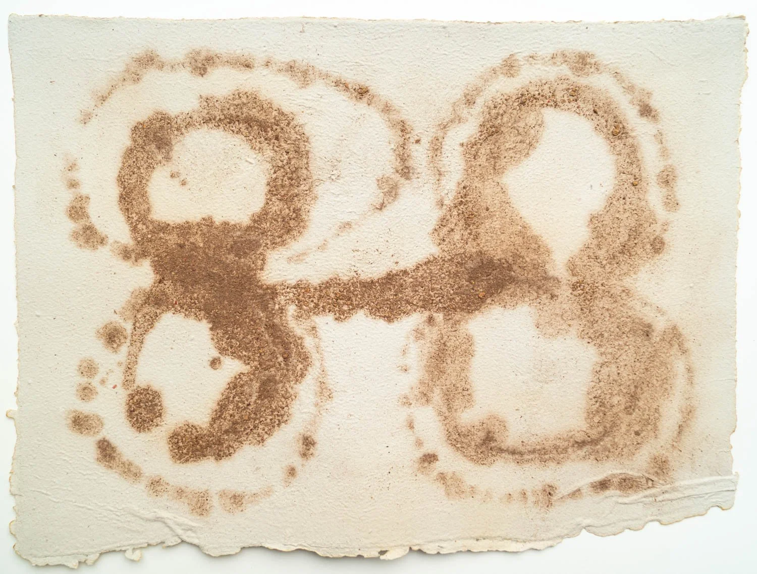 Number 2023 written on a textured, creme-colored paper with a spray-paint-like effect in brown