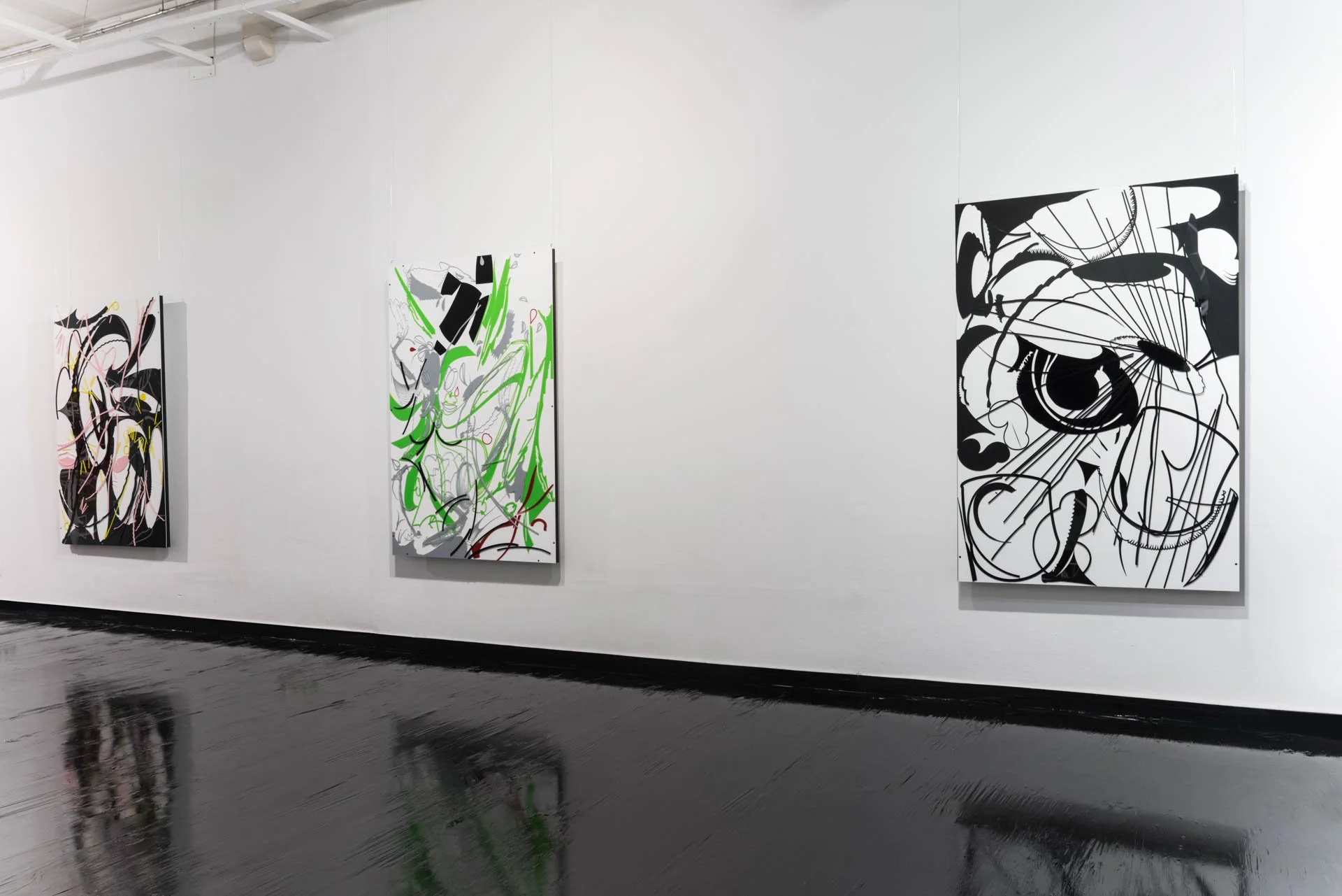 Three abstract paintings on a white gallery wall with black floors reflecting the artwork.