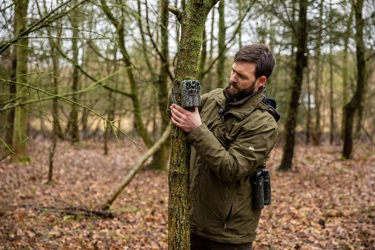 Lloyd fitting a camera trap in Boothby Wildland