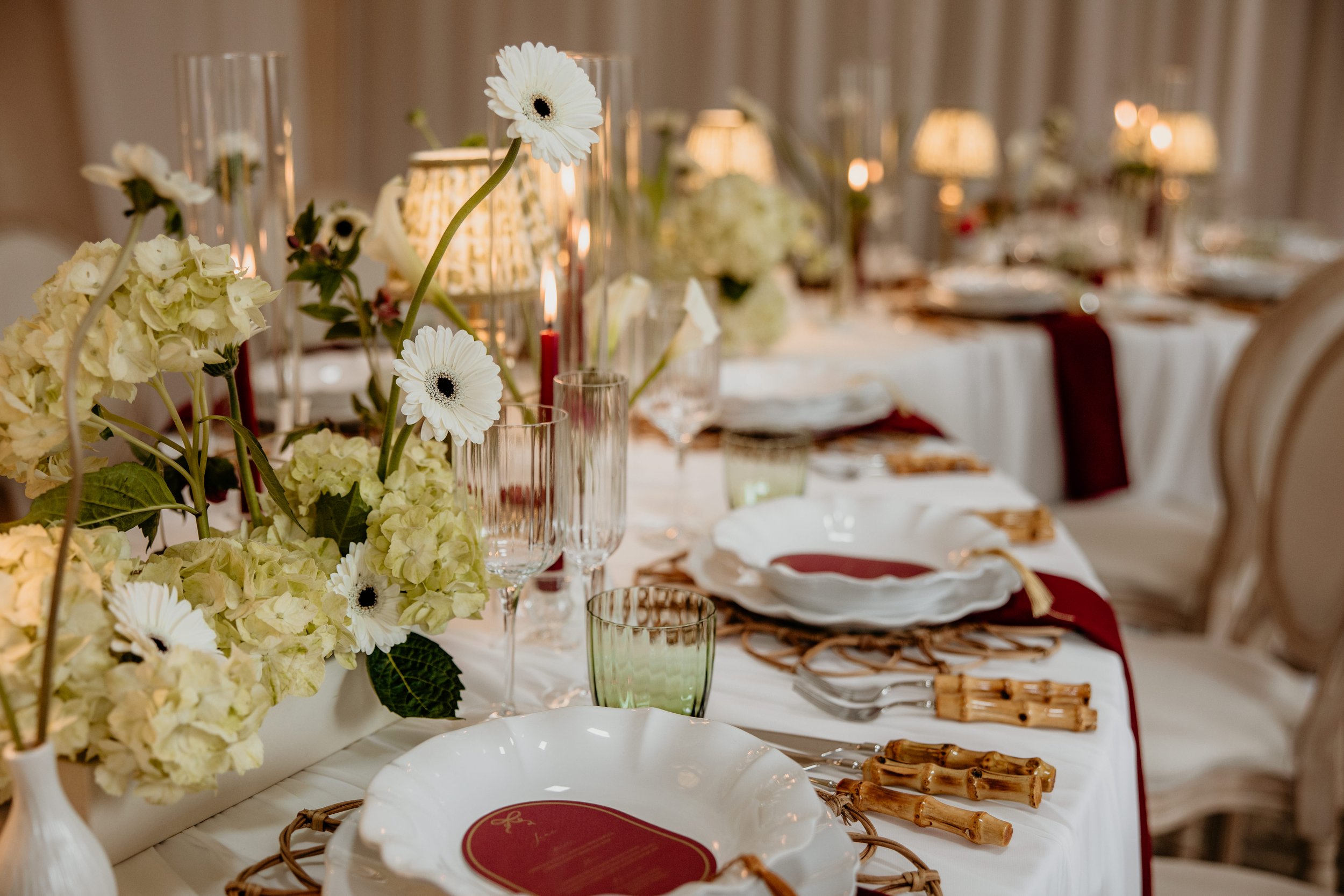 Event table setting with florals and fine china at Oxleaze Barn, Cotswolds