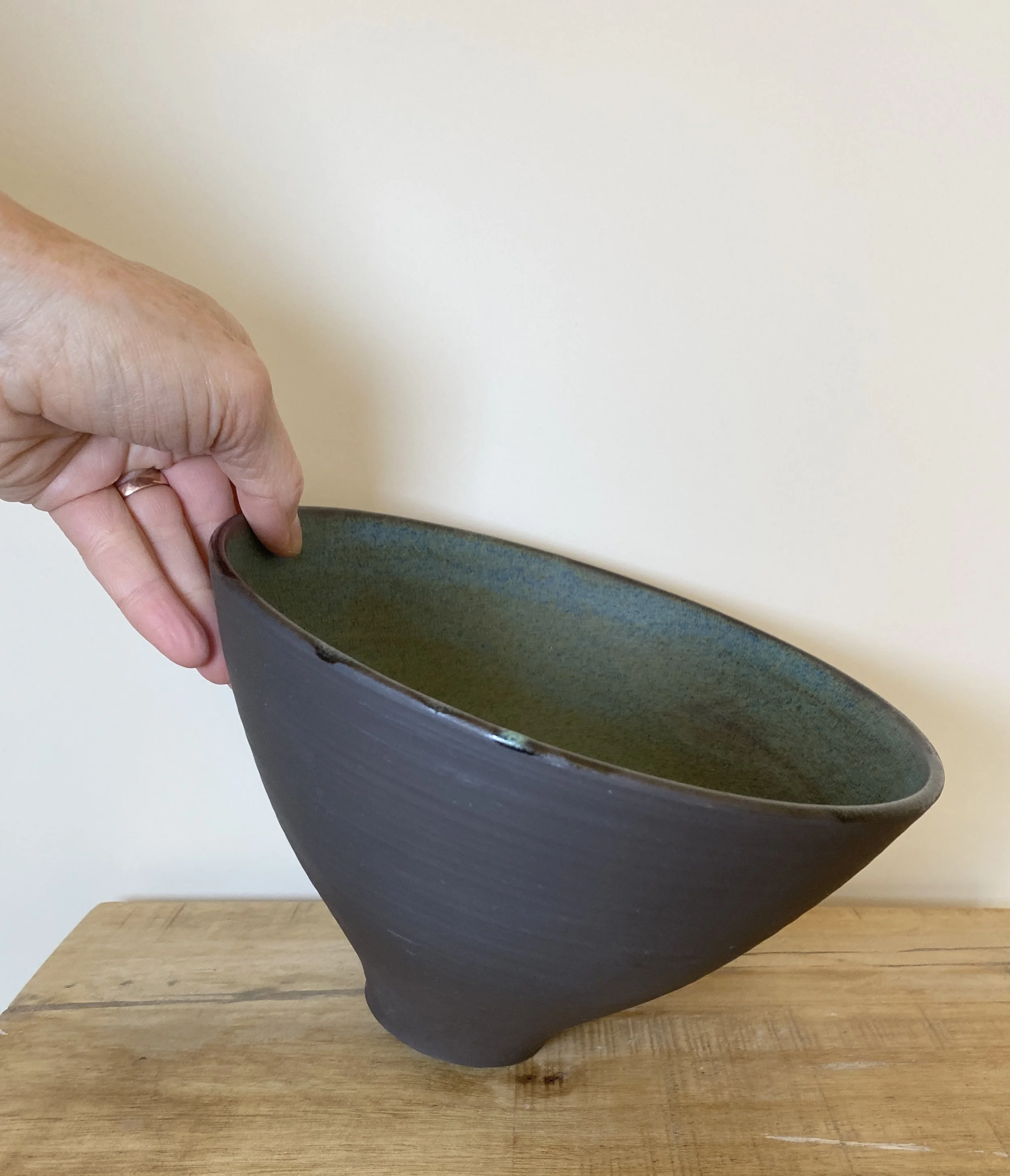 Black clay bowl with blue/green glaze