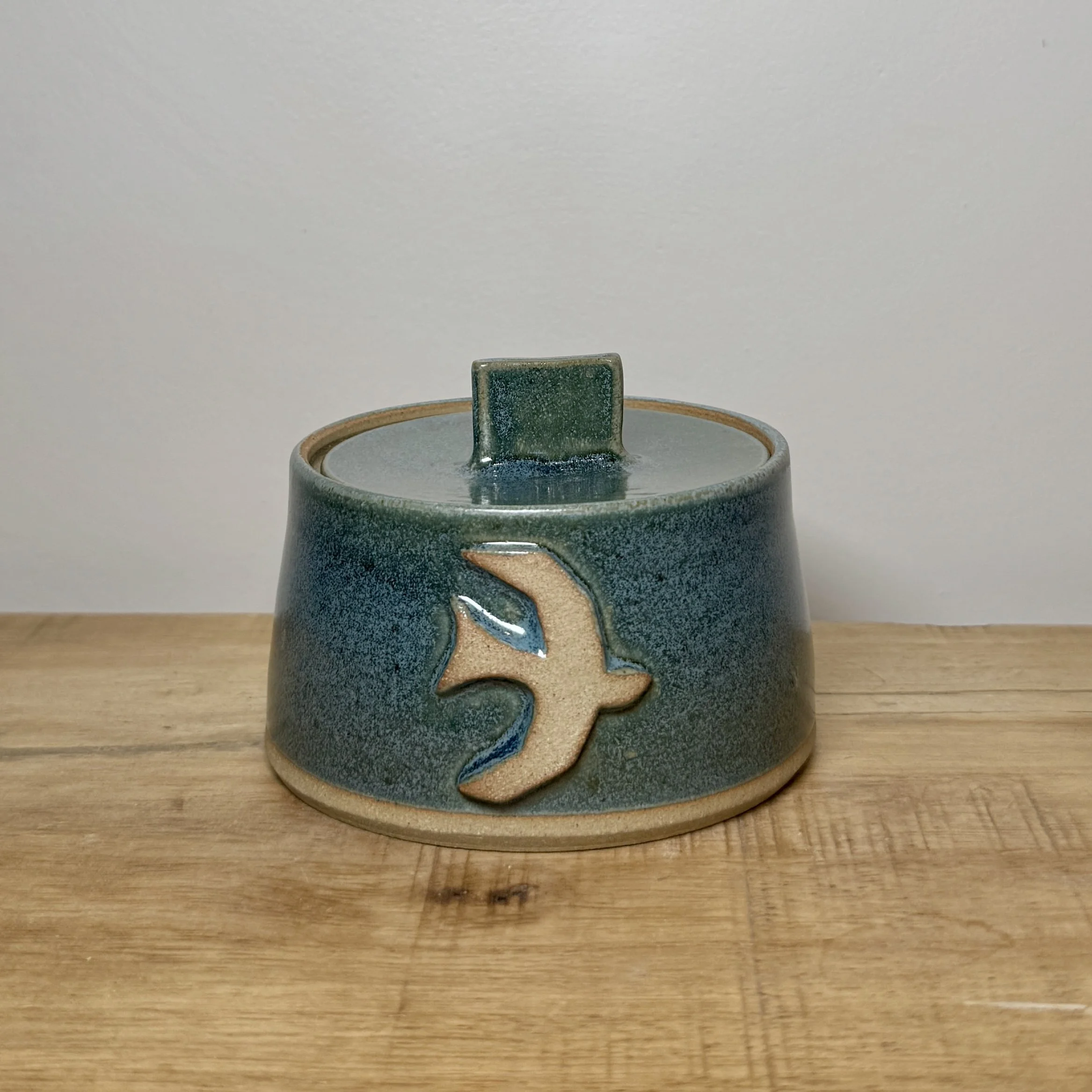 Small lidded pot with bird design - green glaze