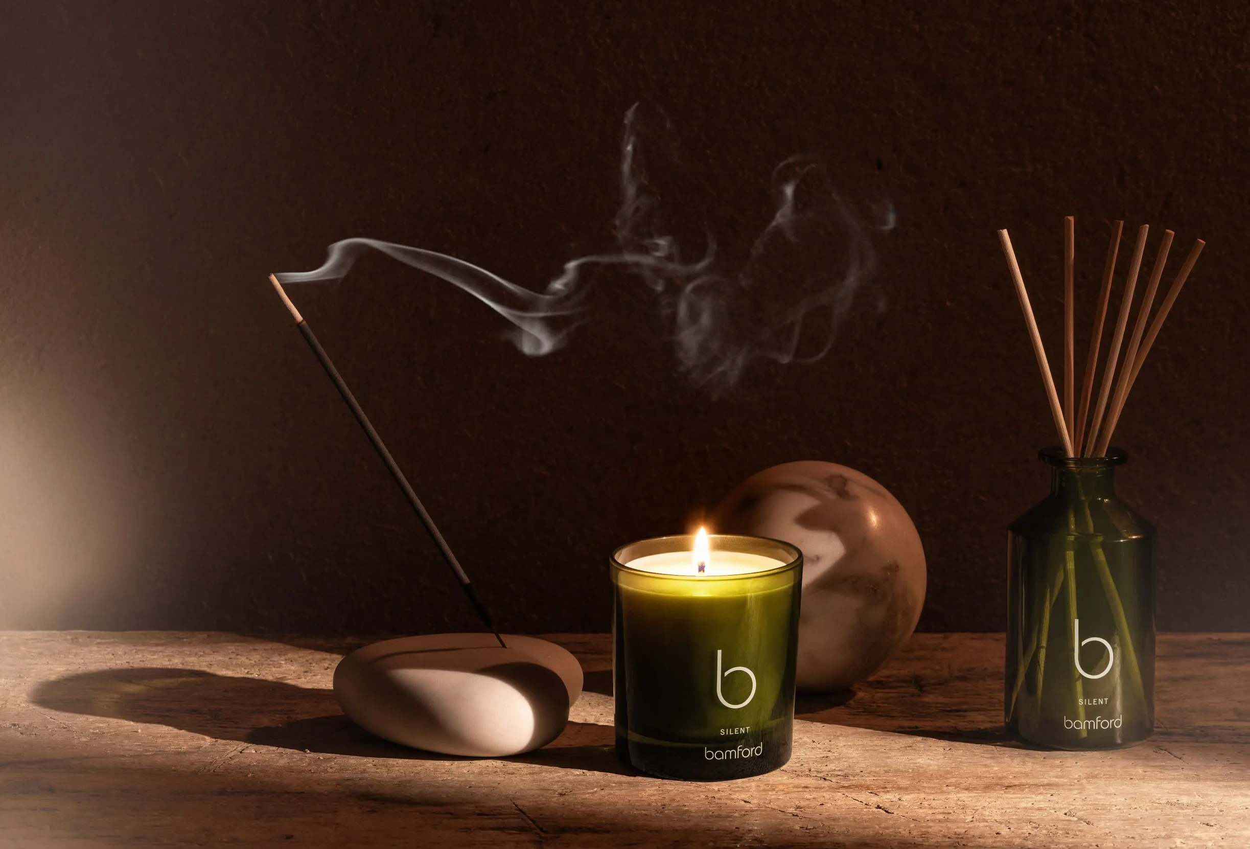 Bamford luxury home fragrance with incense sticks, candle and diffuser in warm moody setting