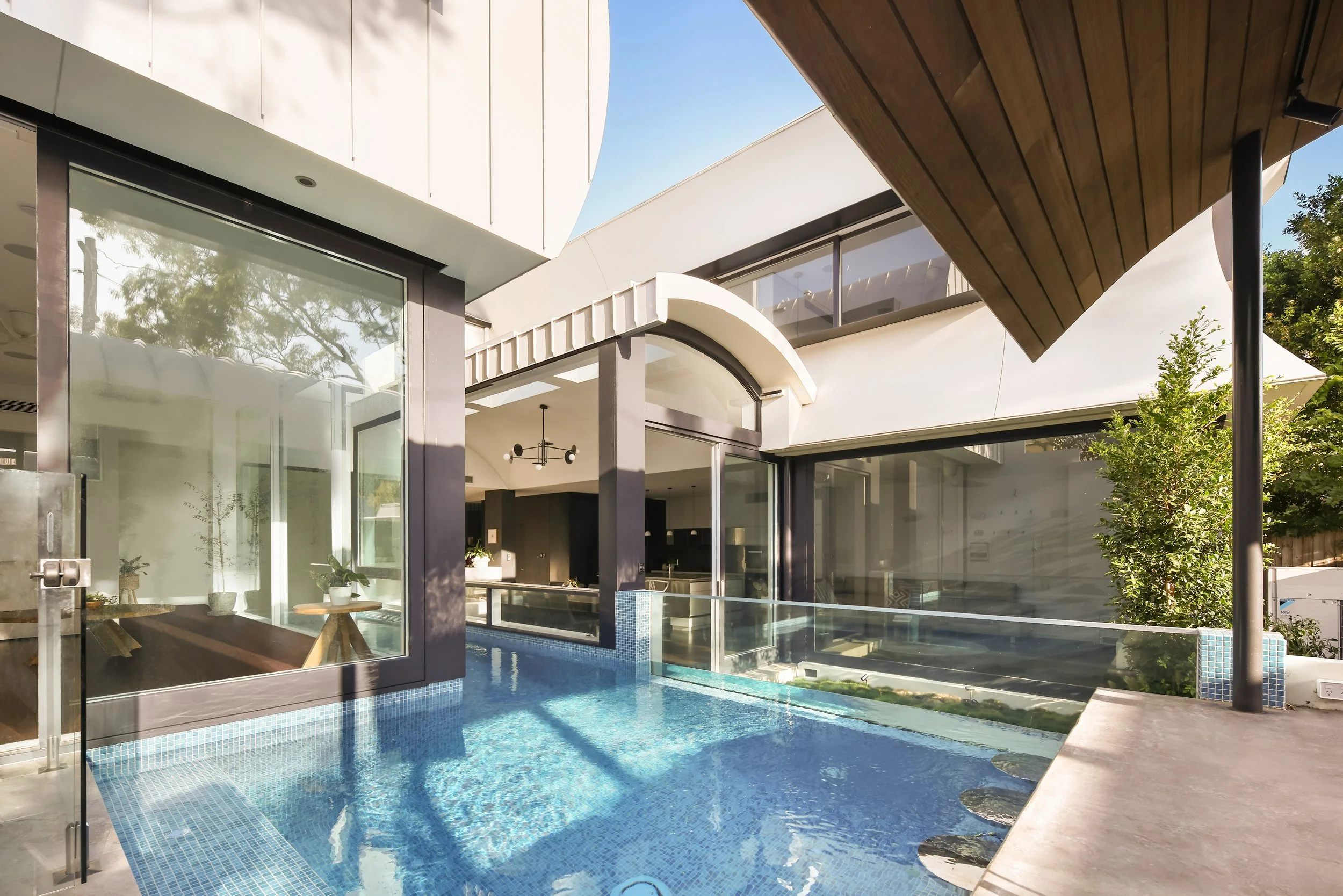 Outdoor pool with glass walls build by Reef Pools Cronulla