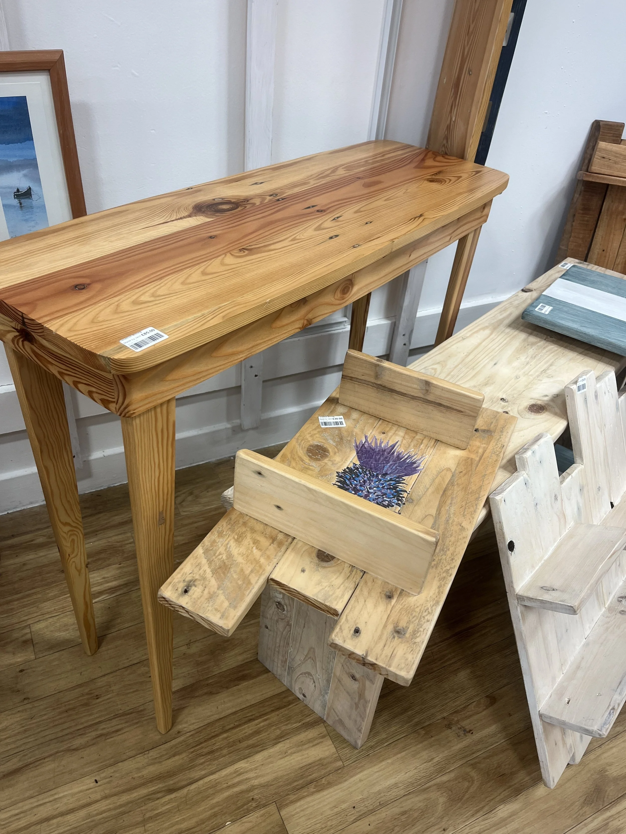 small pallet wood shelving unit with painted thistle design