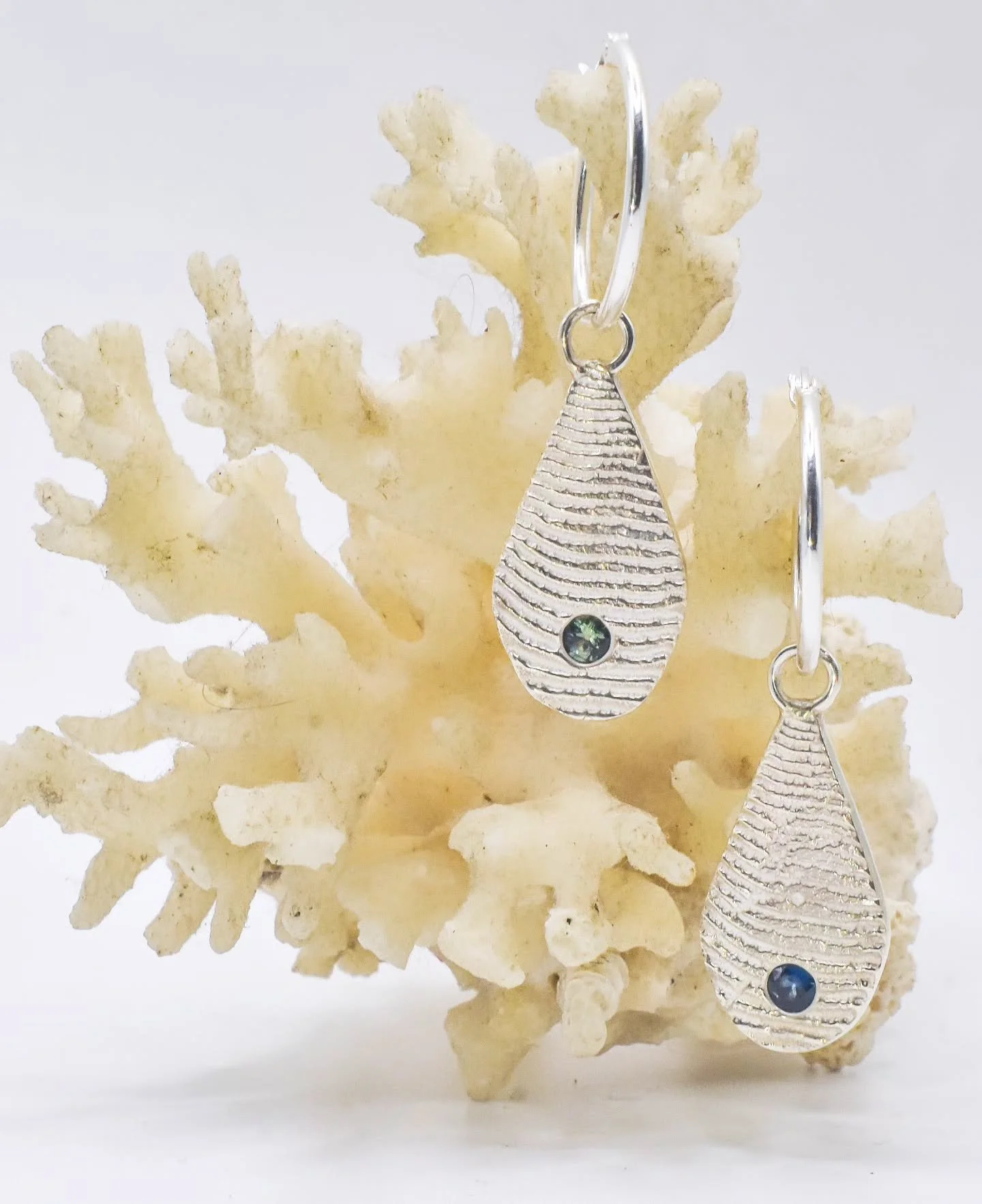 Carved from cuttlefish bone. Cast with silver. 
Studded with sapphires. Hung from your ears.

A celebration of sea life 🩵🦑💙