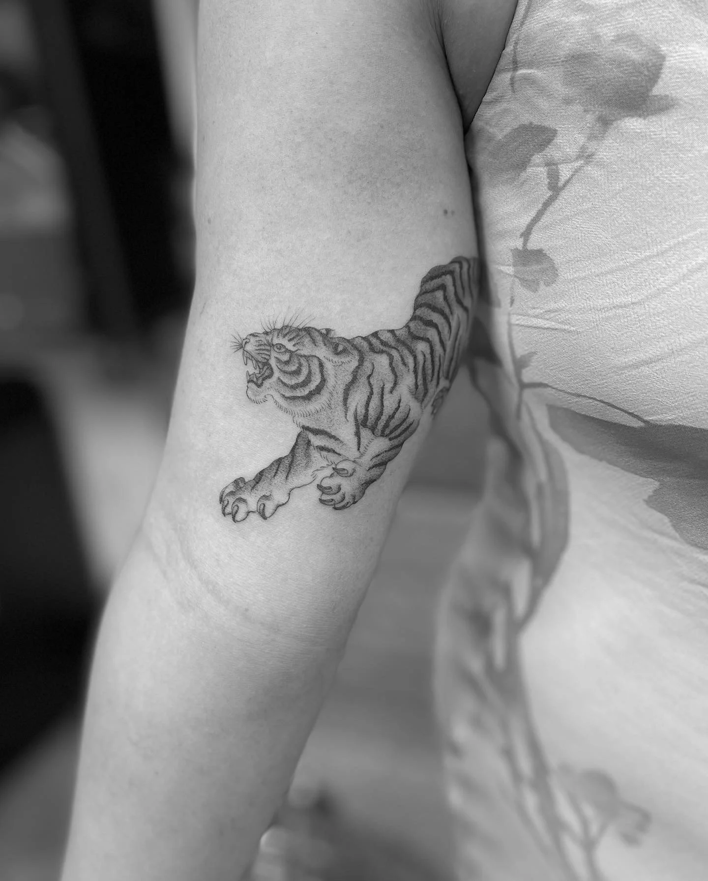 Single needle black and grey tiger tattoo on the arm, done at Frith Street Tattoos, Soho, central London.
