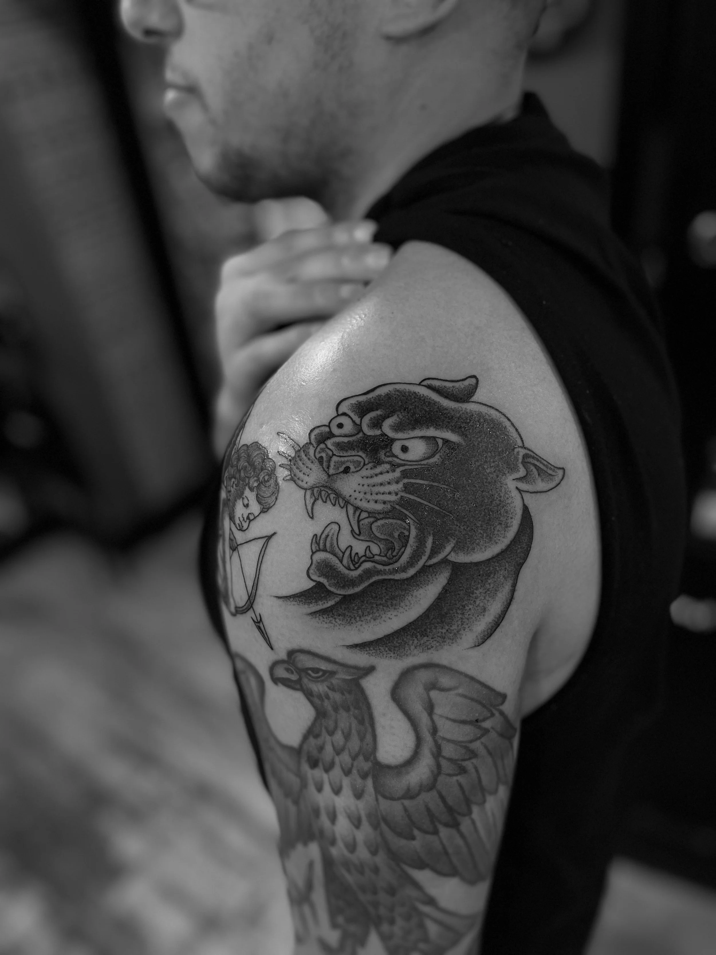 Fine line, black and grey panther head tattoo, done at Frith Street Tattoos, Soho, central London.