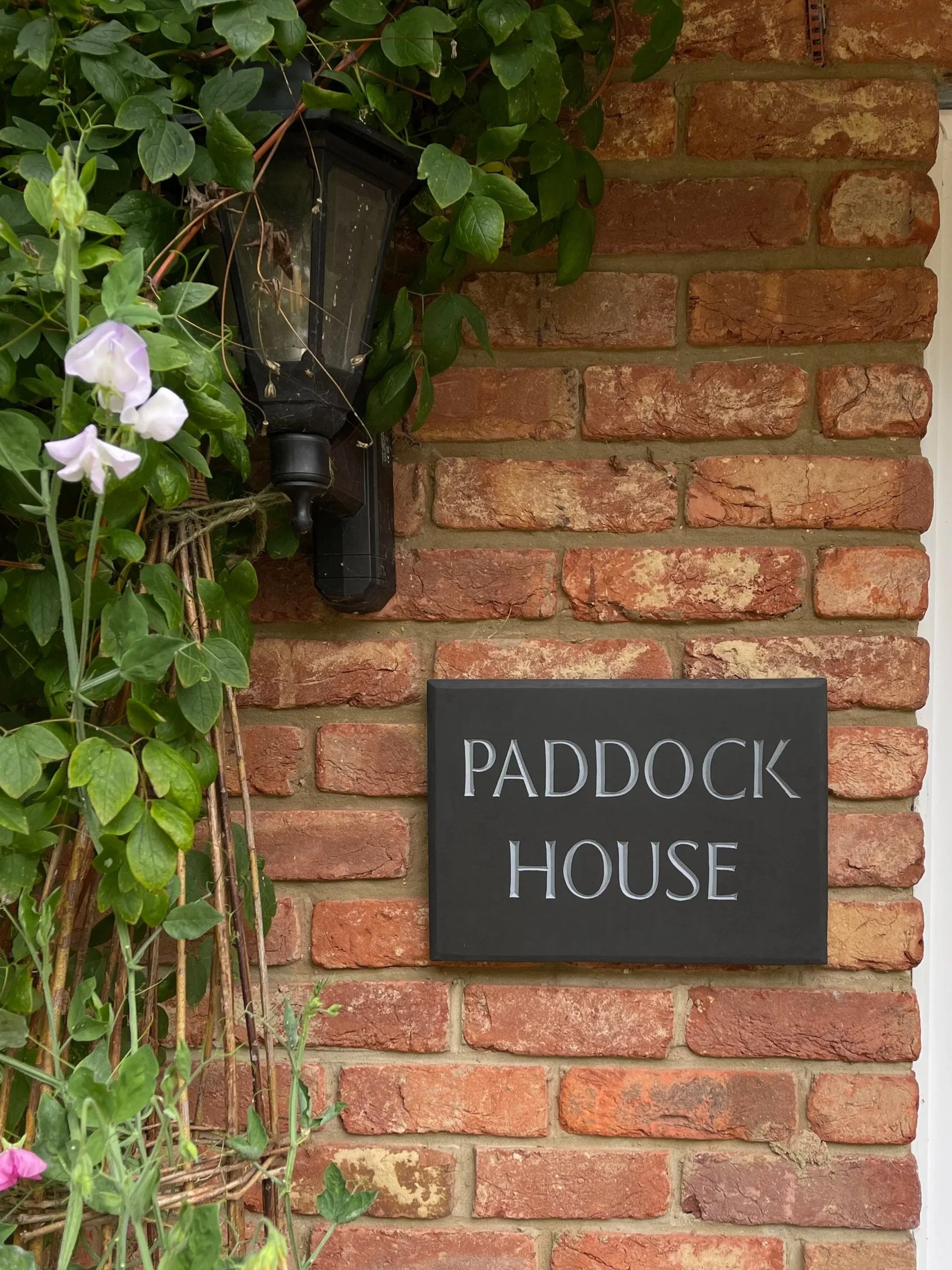 House sign carved in slate and painted.
