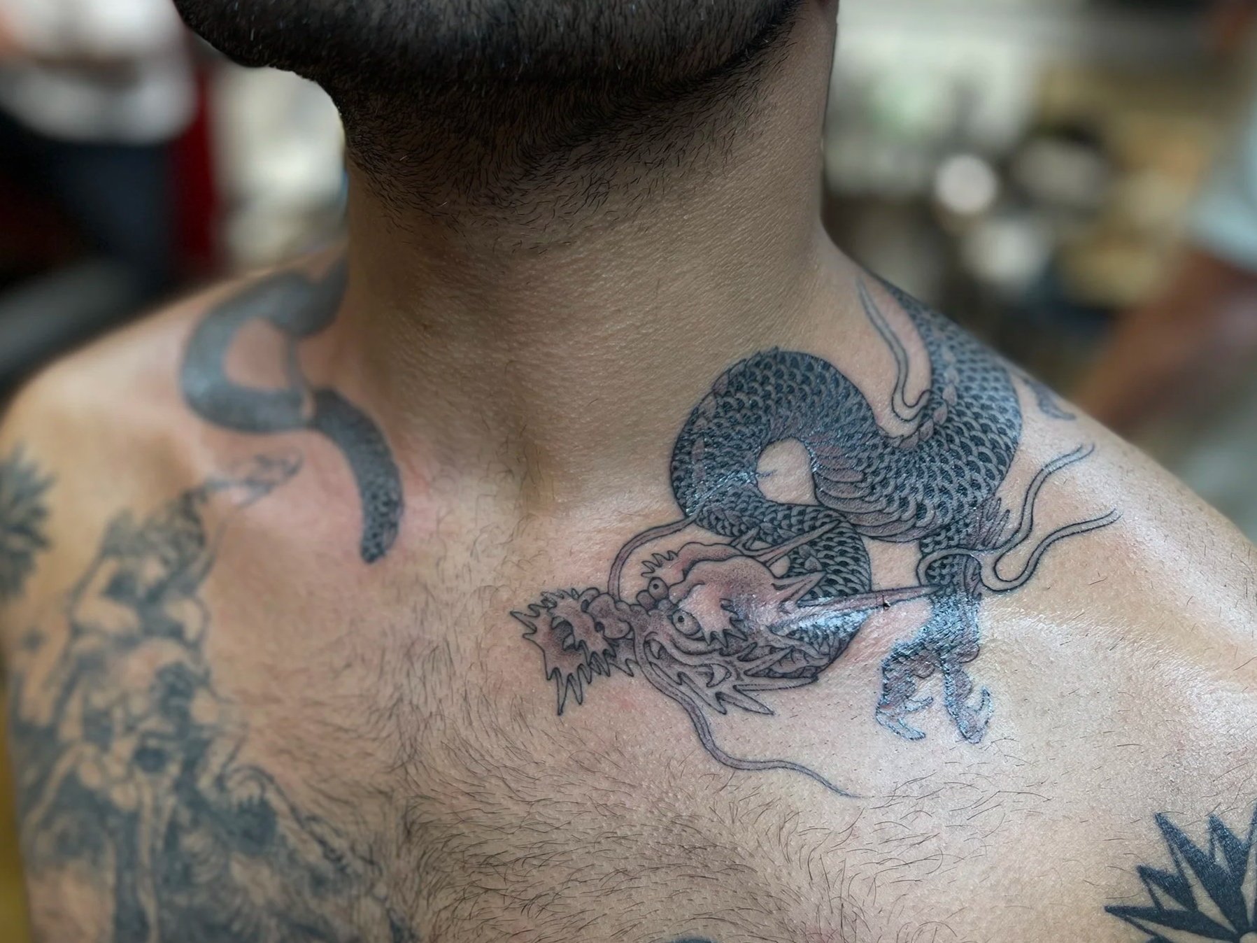 Fine line Japanese dragon round the neck. Tattooed in soho, central London.