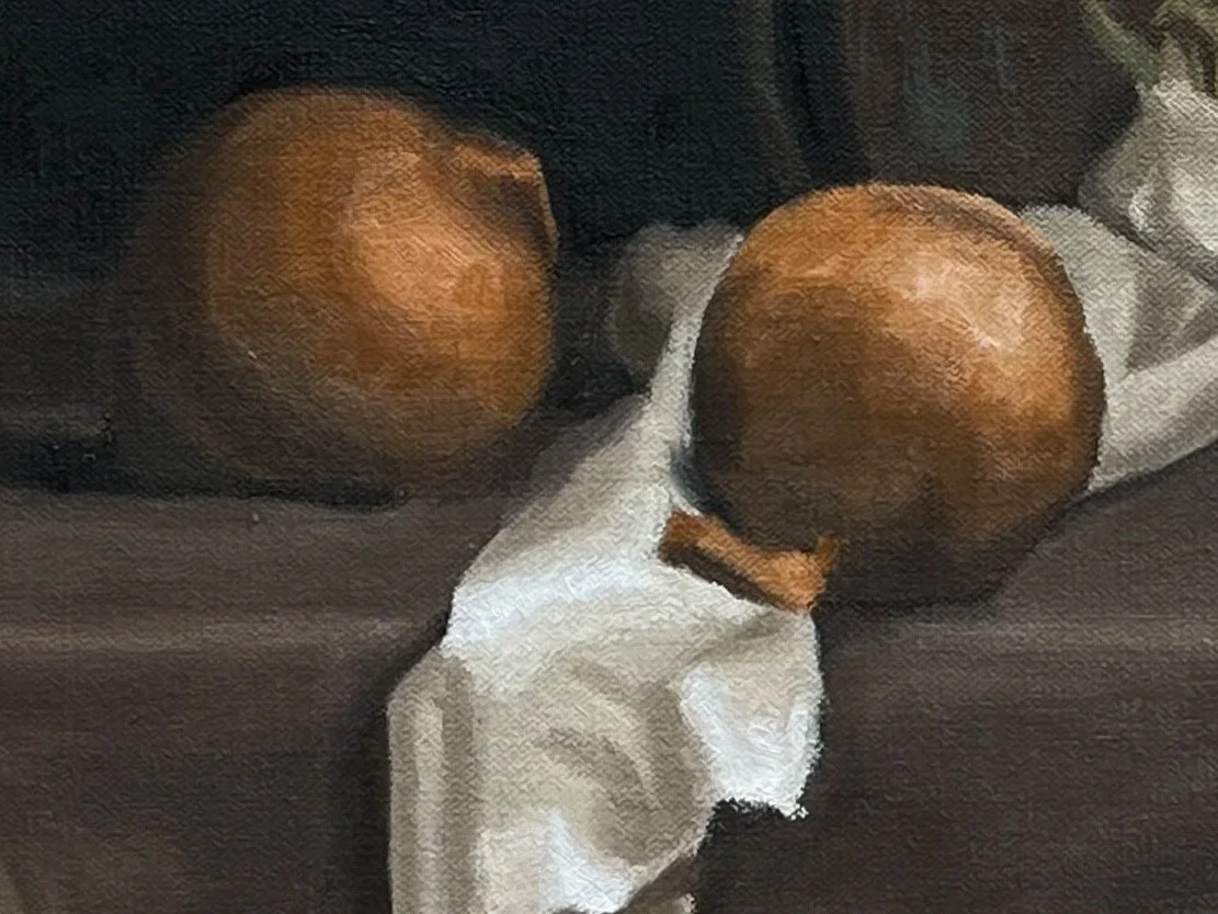 Still life oil painting of onions, garlic, drapery and a copper pot.