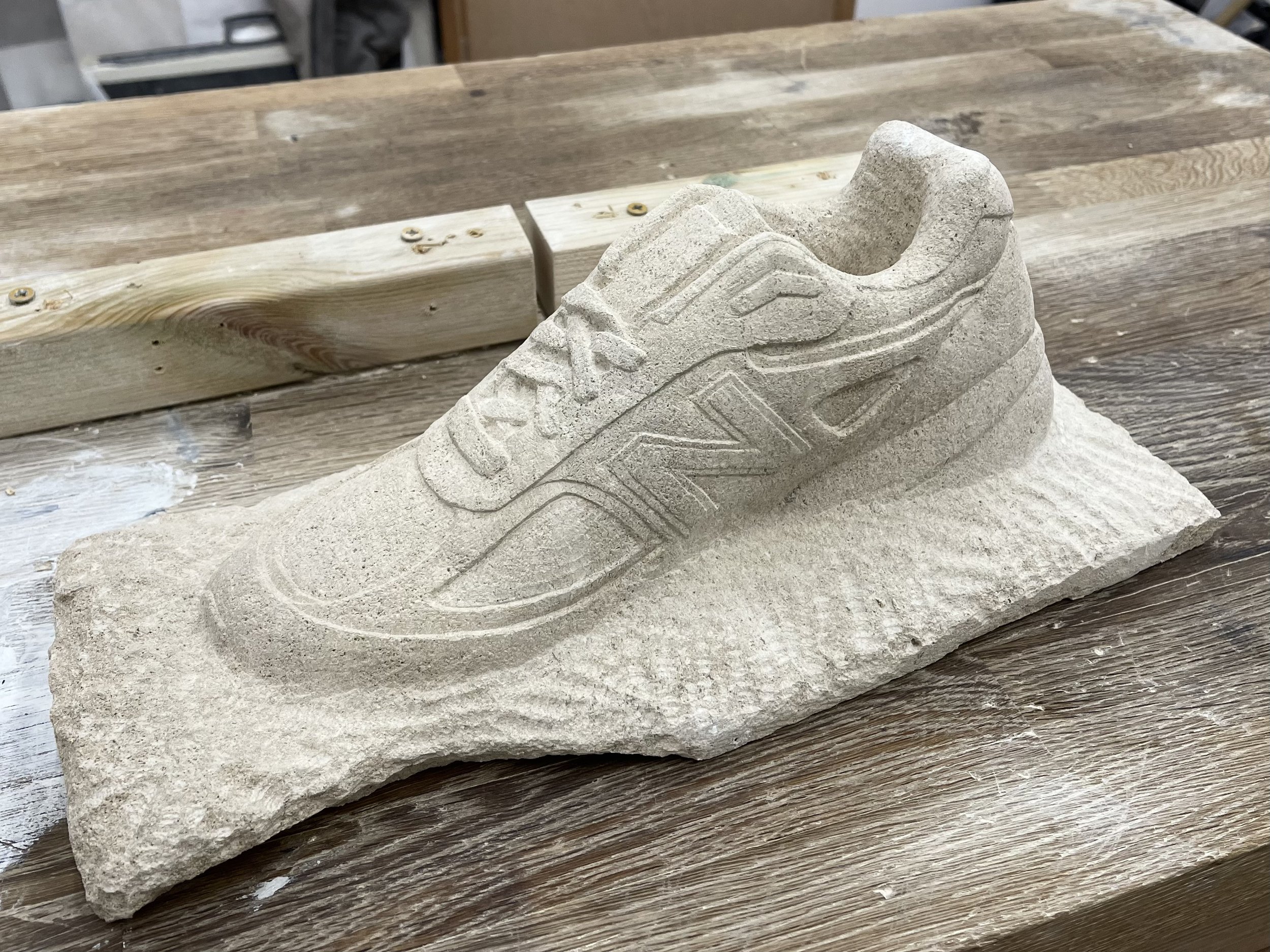 Life-size stone carving of a New Balance trainer, for New Balance at Paris Fashion Week 2026. Carved by hand in West Norwood, south London.