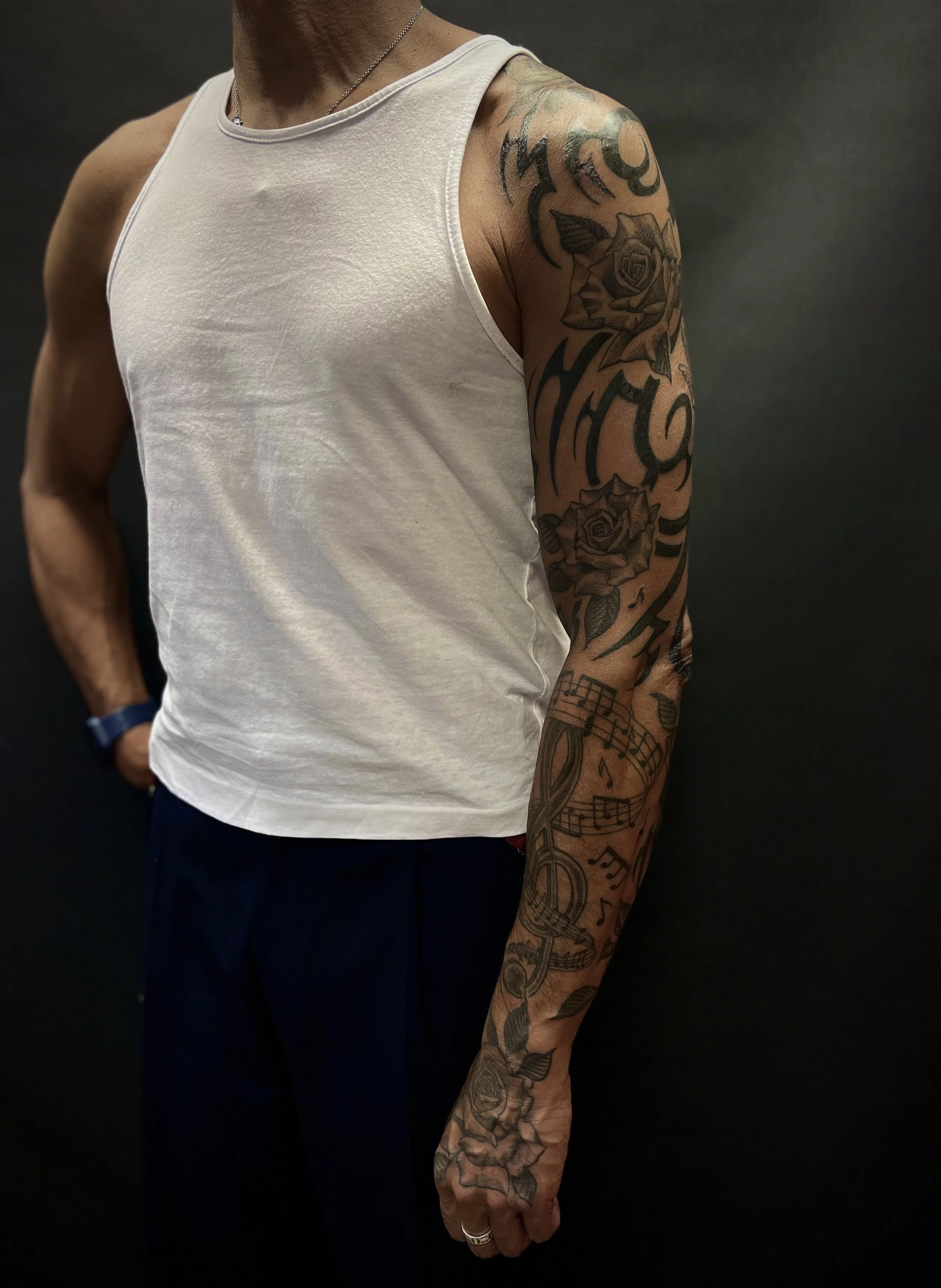 Tribal, rose and music sleeve tattoo, done at Frith Street Tattoos, Soho, central London.