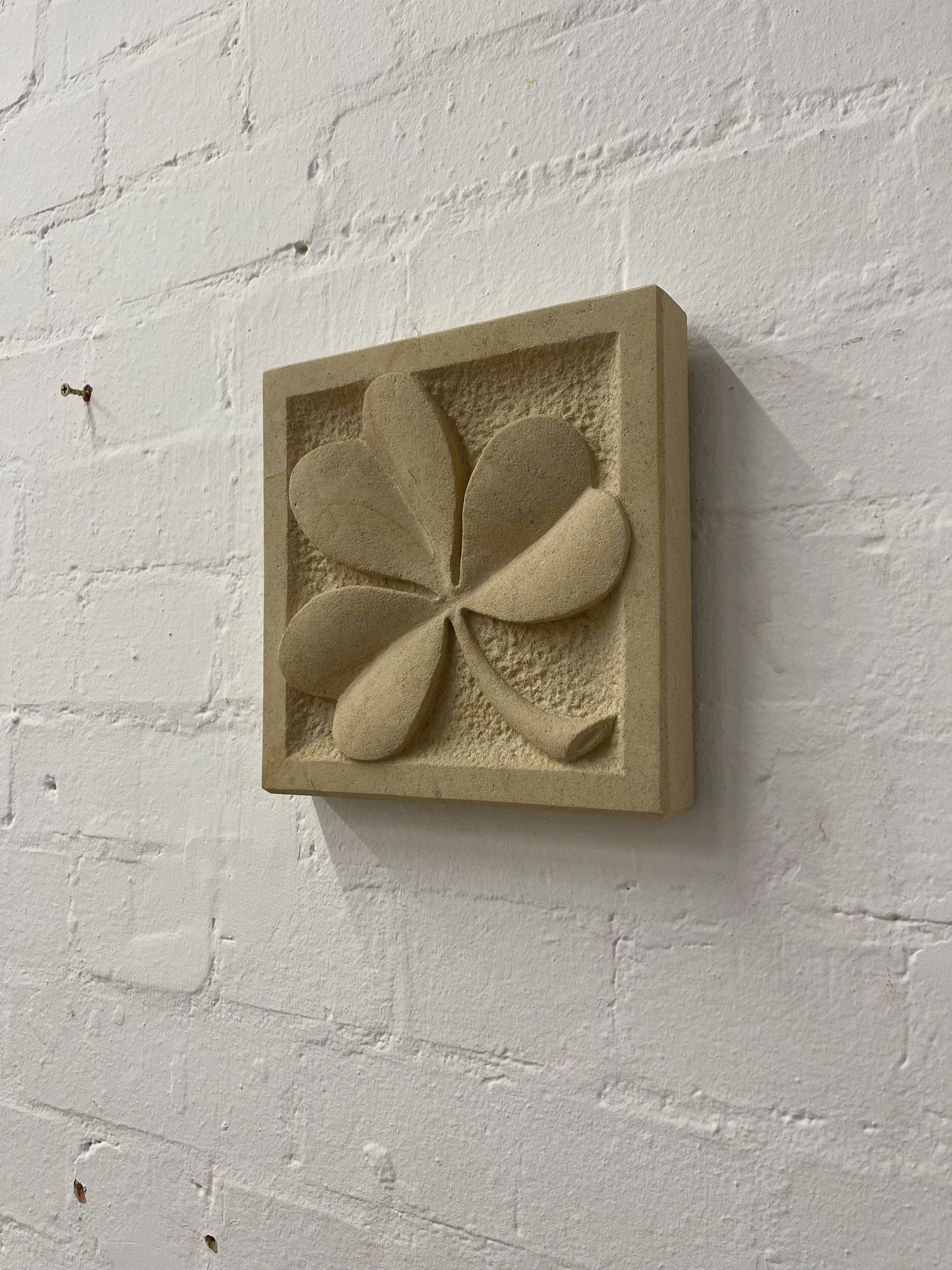Stone carving of a clover or shamrock, in Caen limestone.