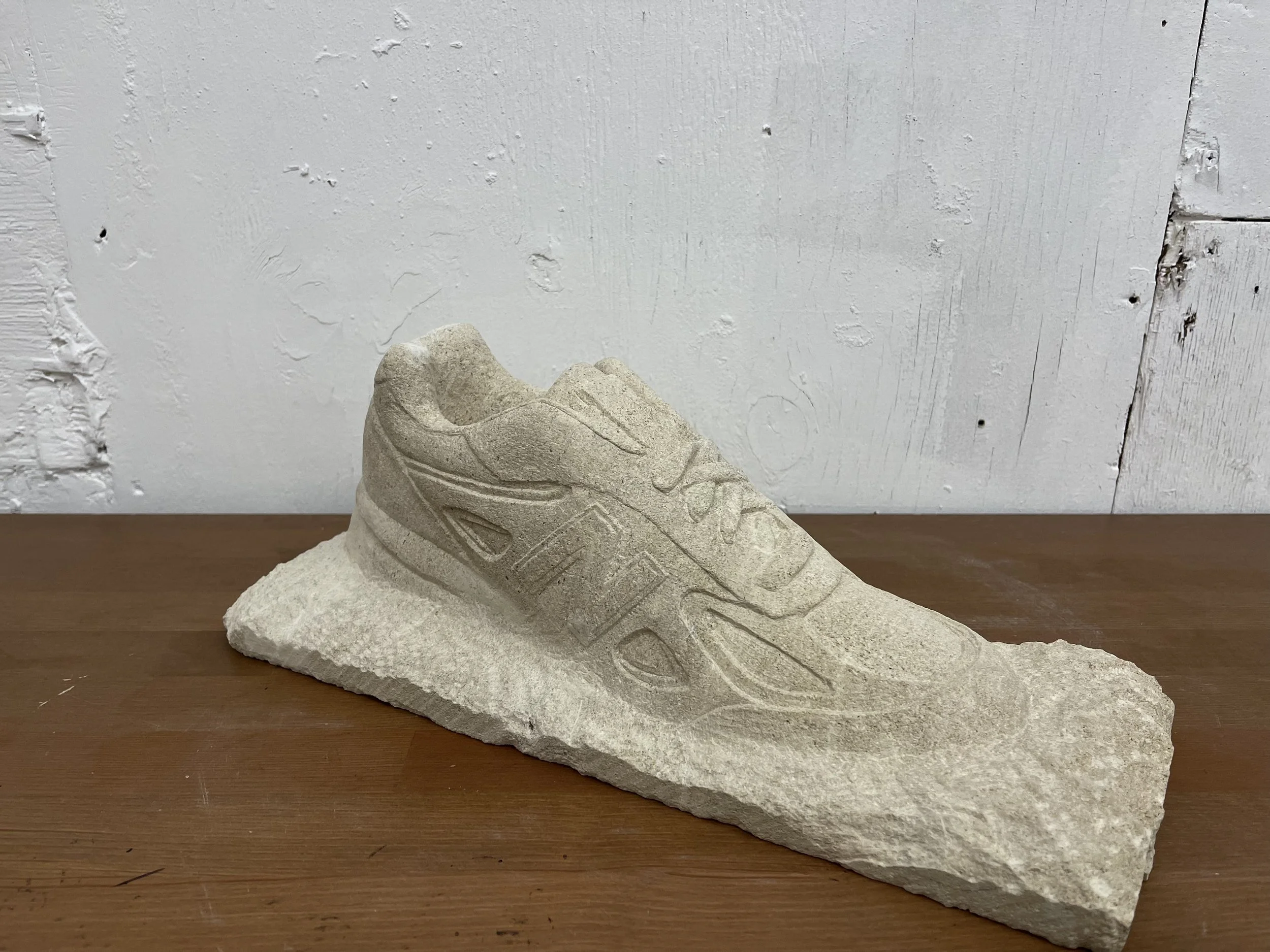 Life-size stone carving of a New Balance trainer, for New Balance at Paris Fashion Week 2026. Carved by hand in West Norwood, south London.