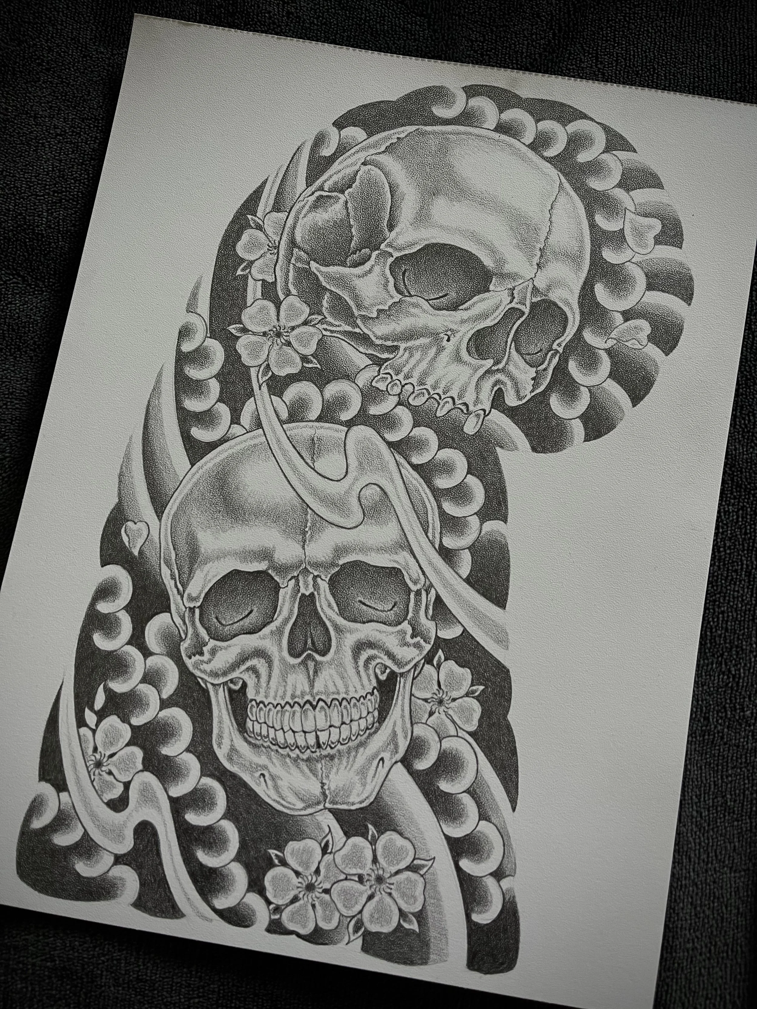 Fine line Japanese skull and cherry blossom half sleeve tattoo design, right arm.