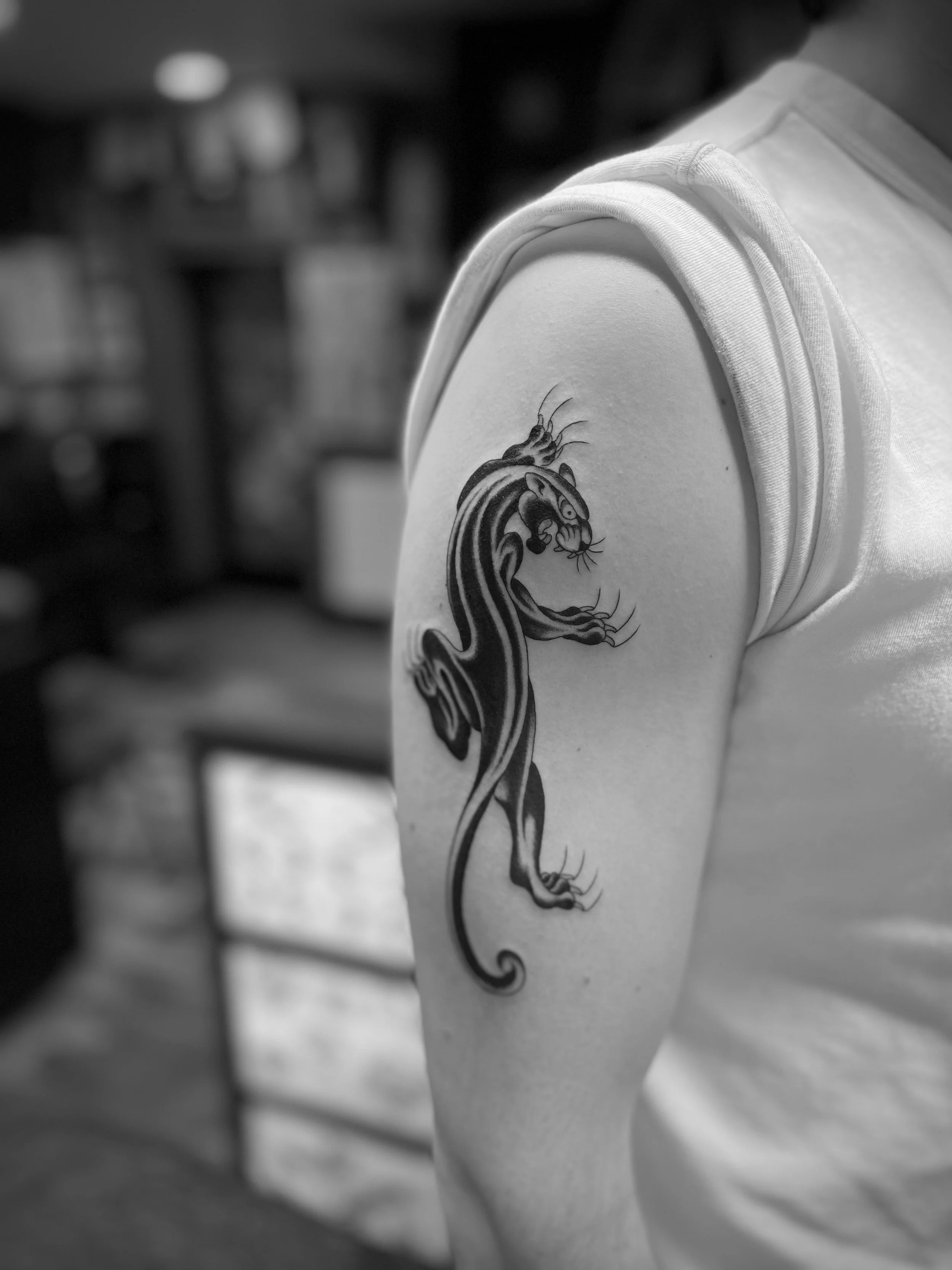Fine line traditional panther tattoo on the arm, done at Frith Street Tattoos, Soho, central London.