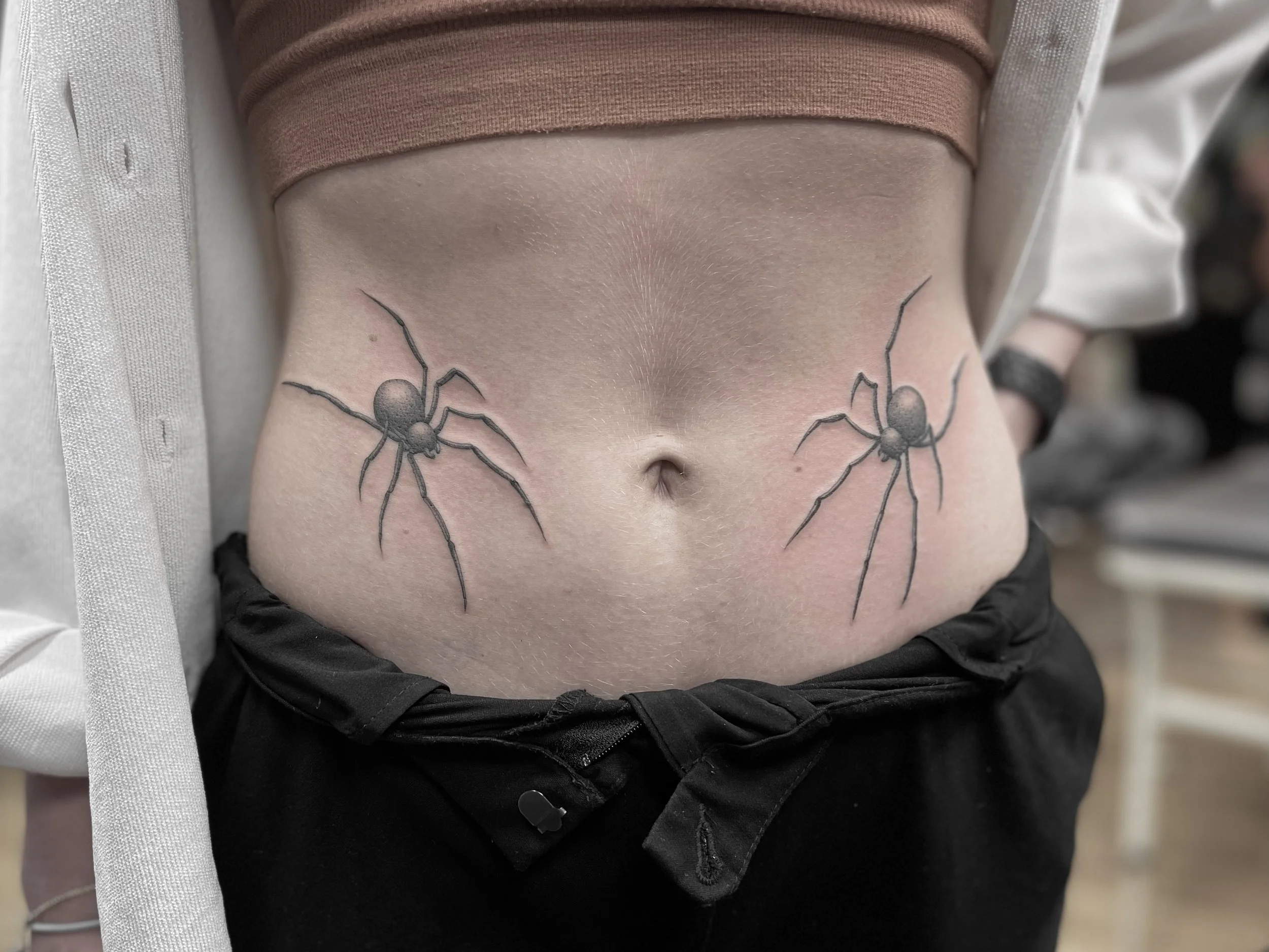 Single needle, black and grey spider tattoos on the belly, done at Frith Street Tattoos, Soho, central London.
