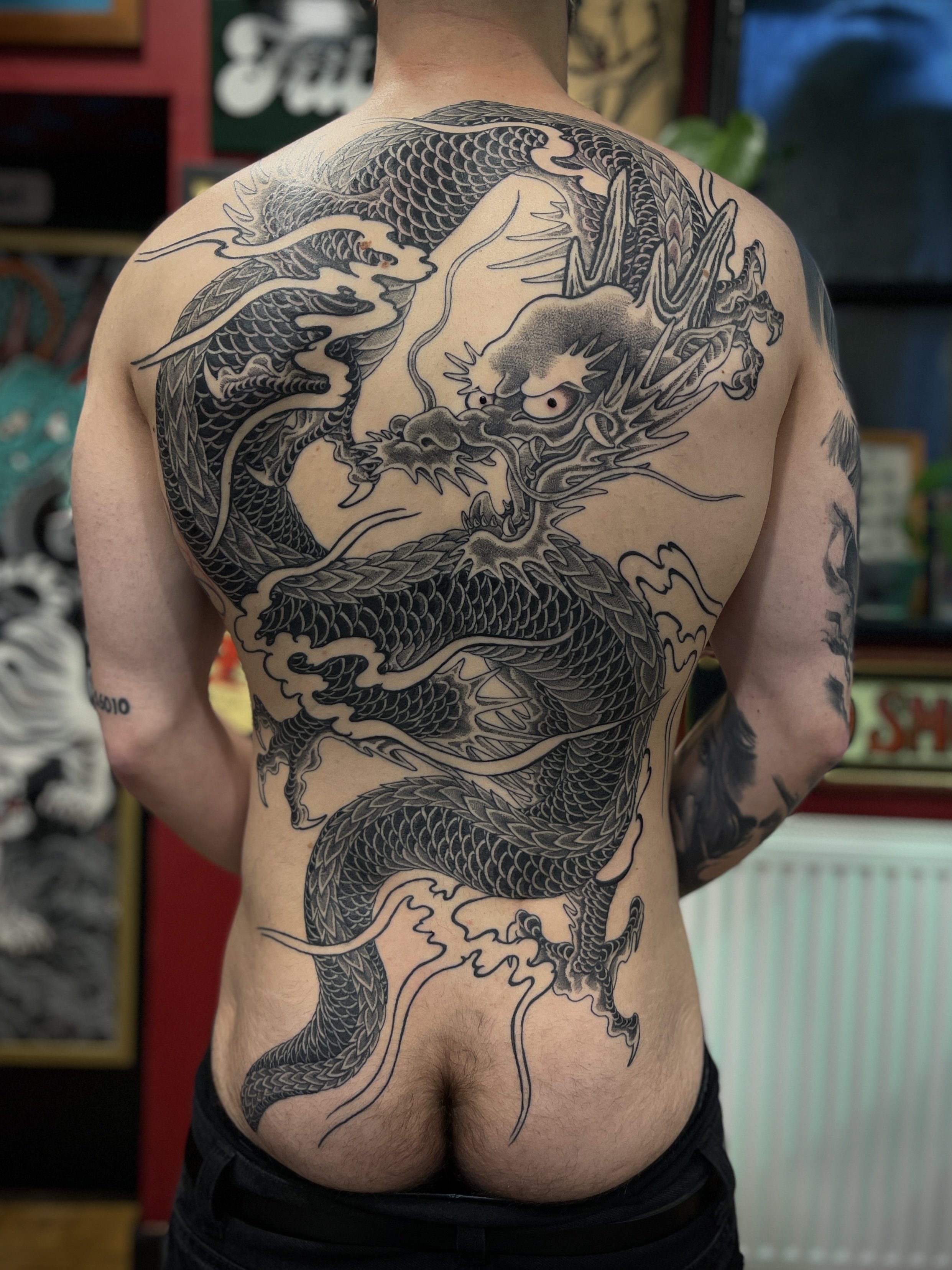 Black and grey dragon back tattoo, done at Frith Street Tattoos, in Soho, central London.