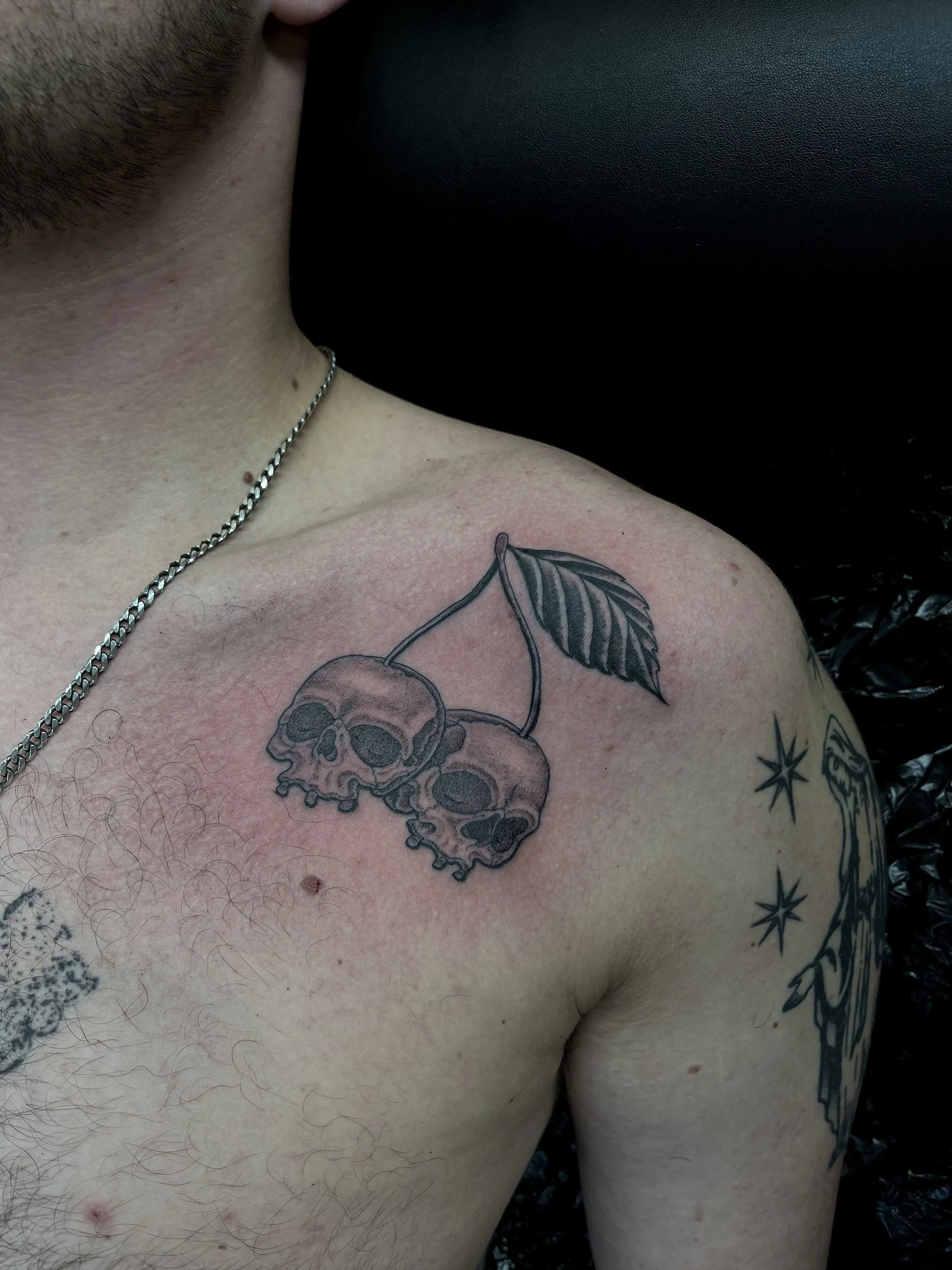 Skull and cherry tattoo, done at Frith Street Tattoos, Soho, central London.