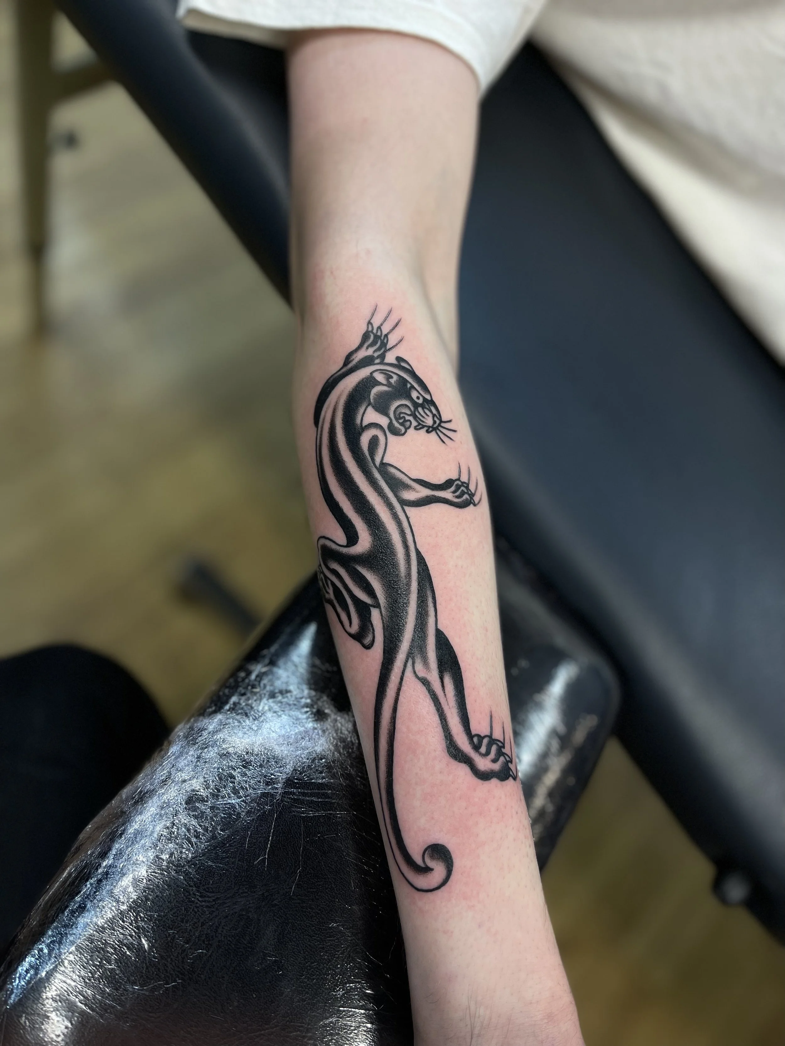 Traditional panther tattoo on the forearm, done at Frith Street Tattoos, Soho, central London.