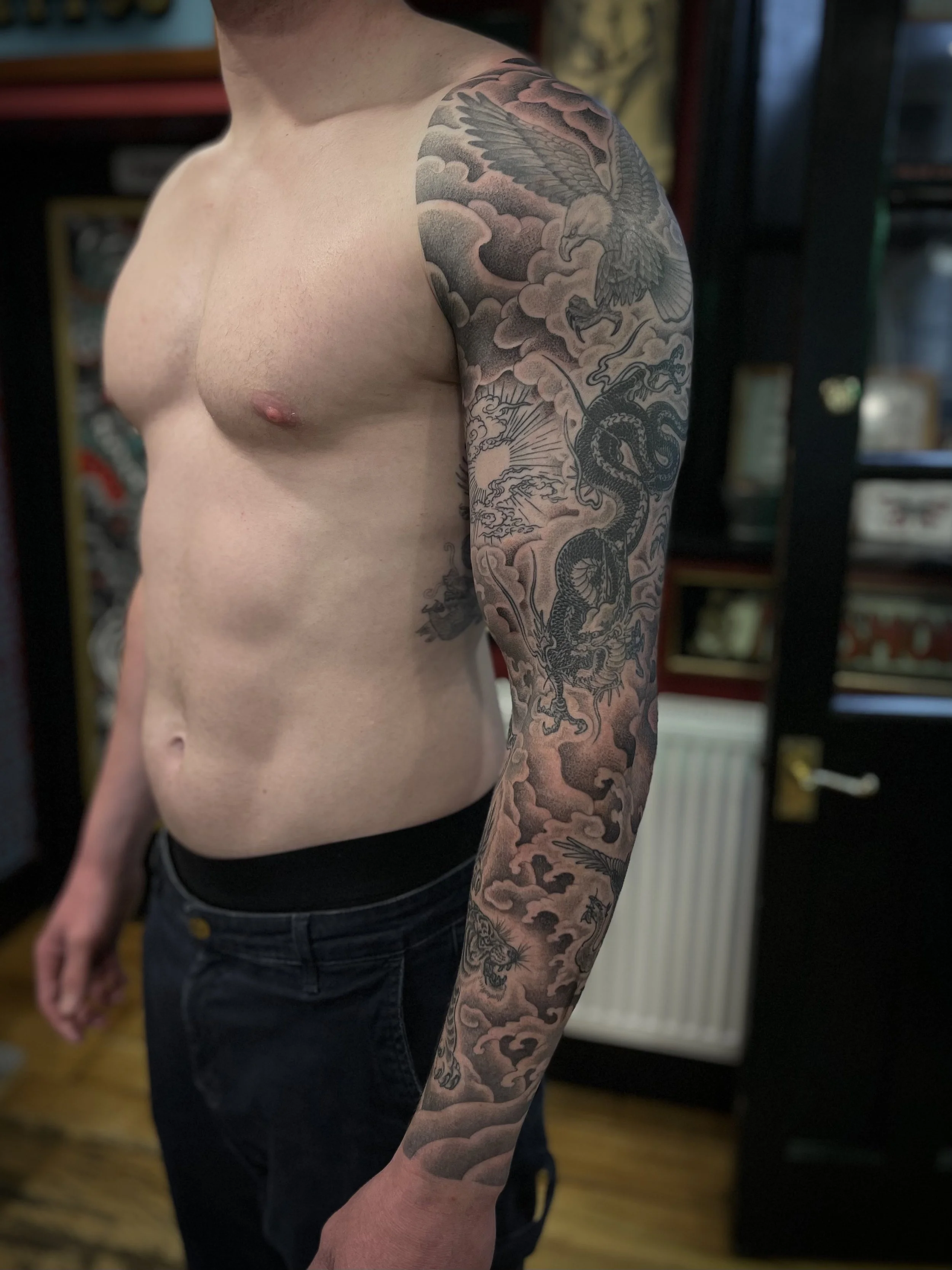 Fine line black and grey sleeve tattoo, done at Frith Street Tattoos, Soho, central London.
