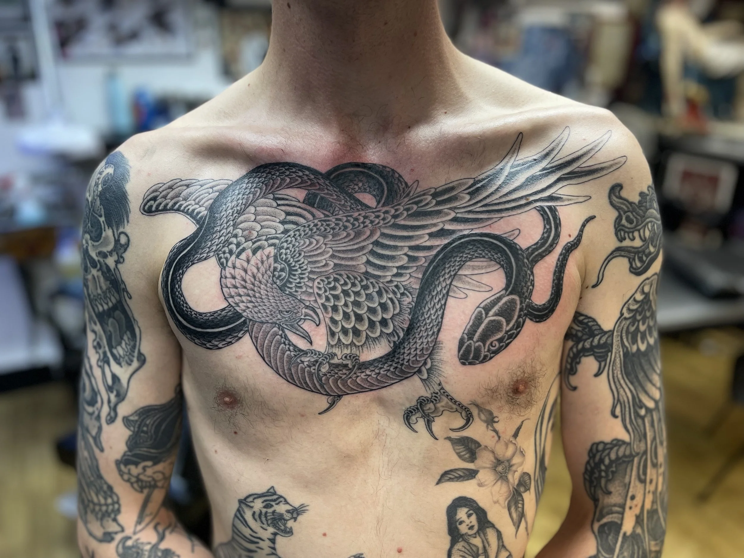 Eagle and snake fine line tattoo on the chest ,done at Frith Street Tattoos, soho, central London.