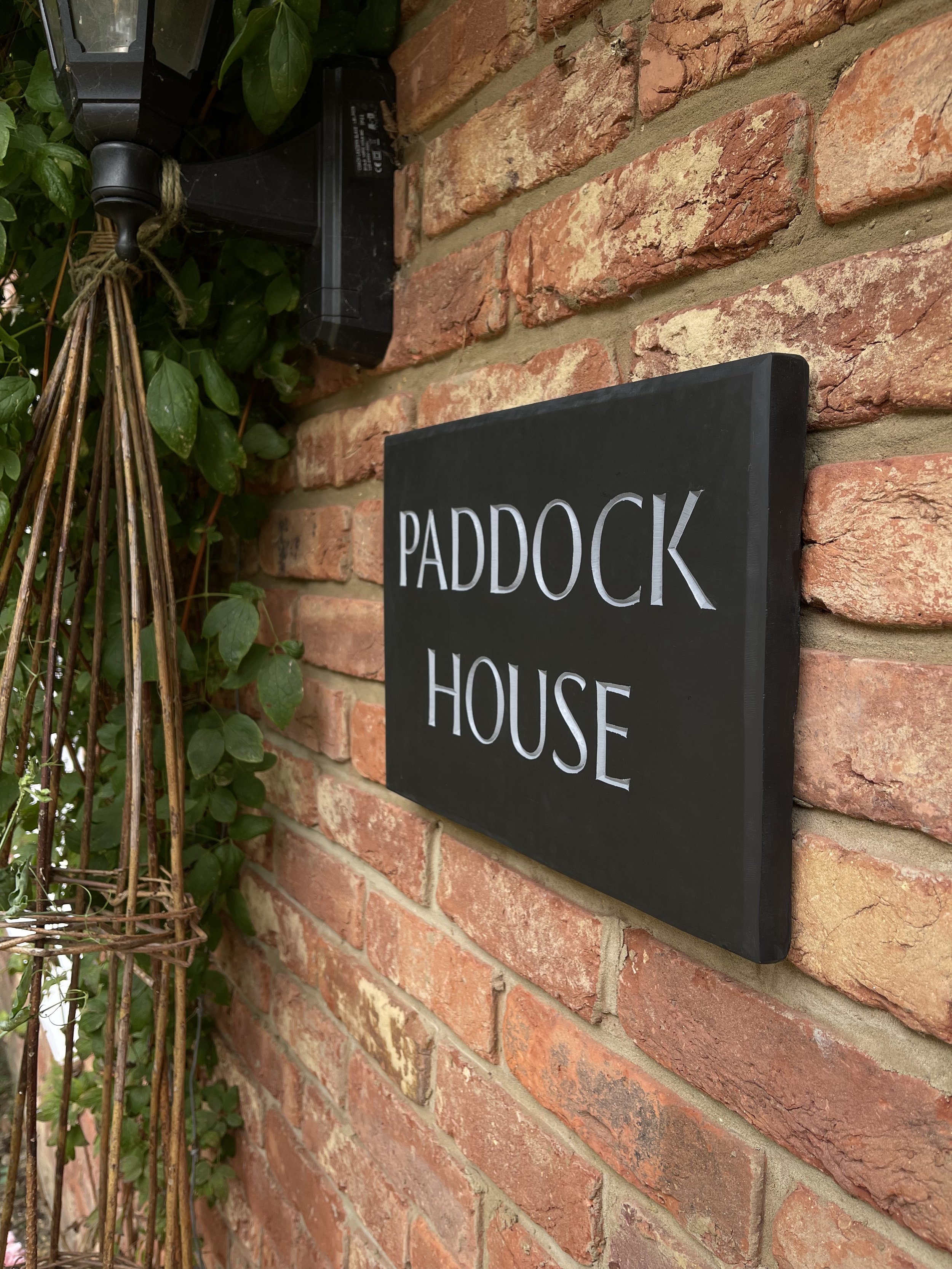 House sign carved in slate and painted.