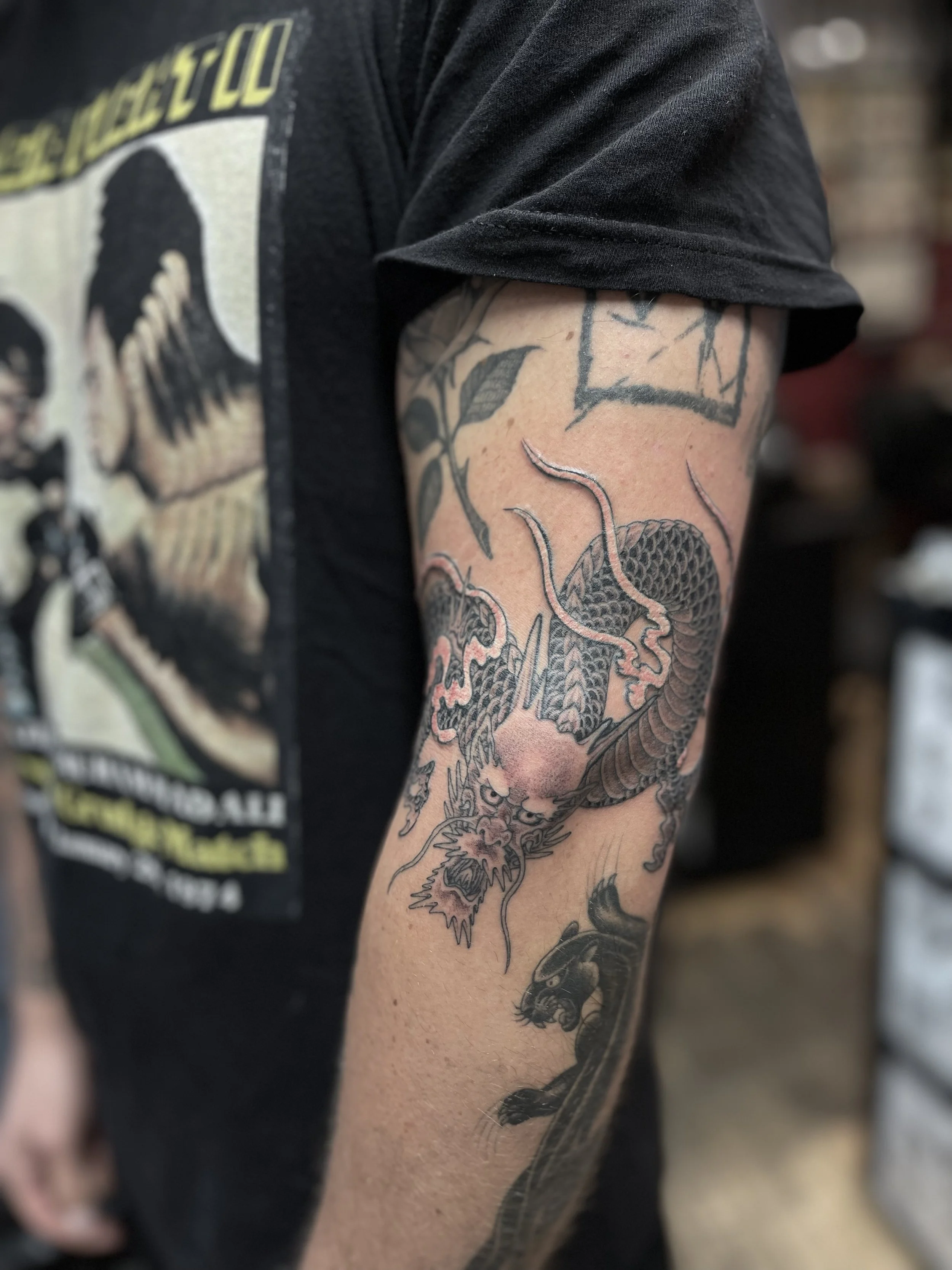 Freehand fine line single needle Japanese dragon tattoo on the arm, done at Frith Street Tattoos in Soho, London.