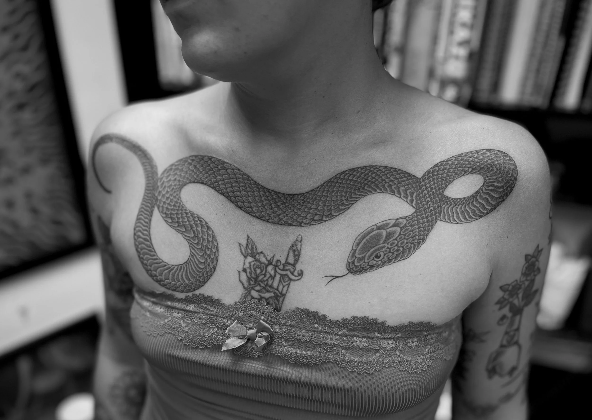Fine line snake tattoo on the chest, done at Frith Street Tattoos, soho, central London.