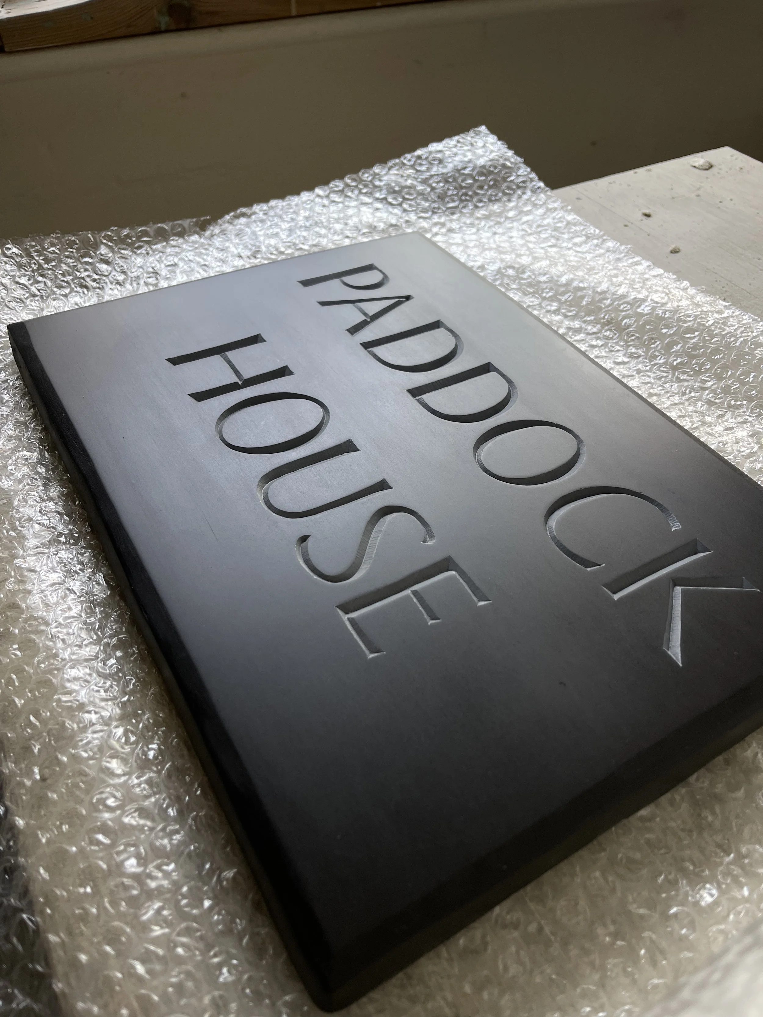 House sign carved in slate and painted.