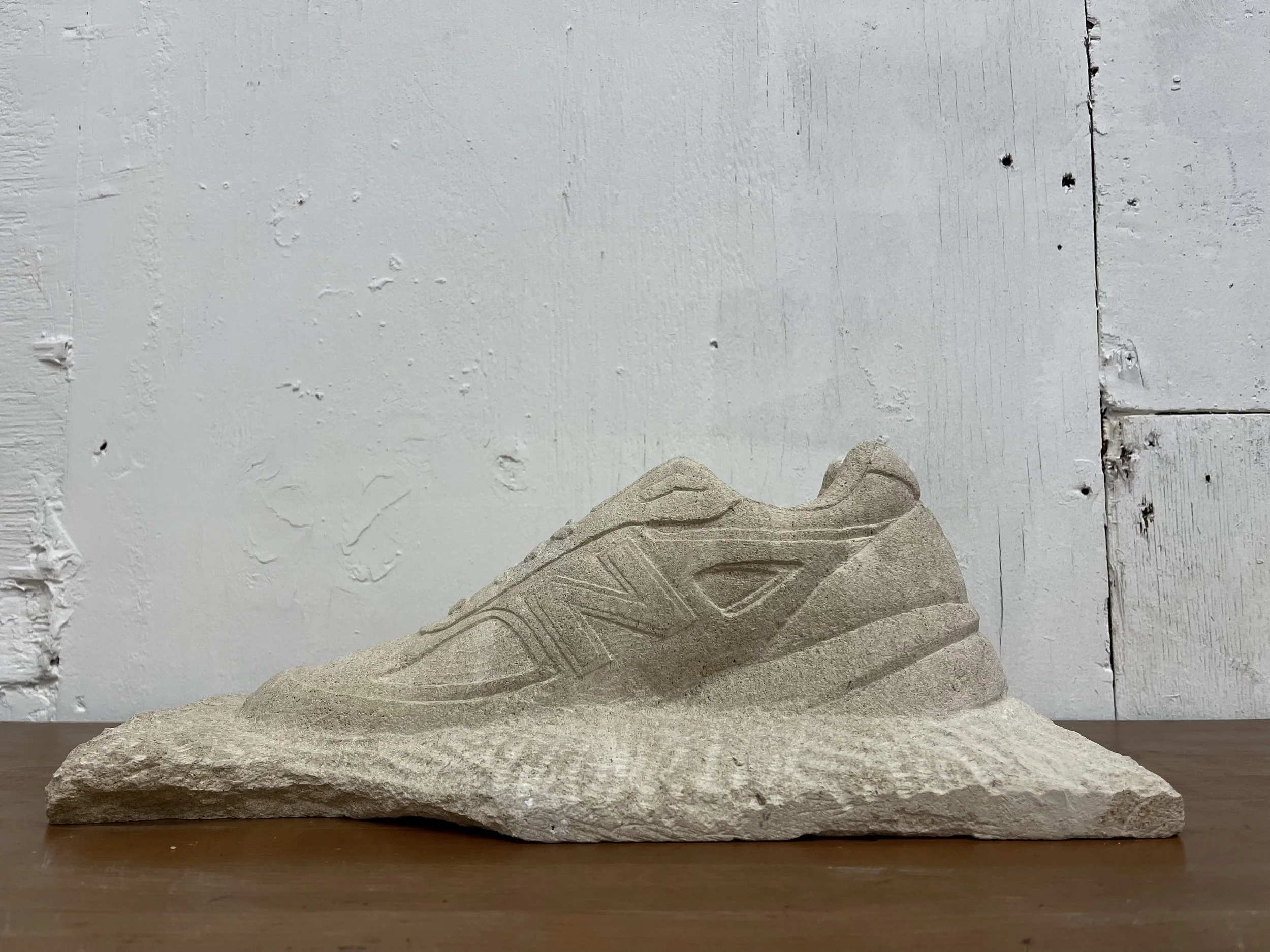Life-size stone carving of a New Balance trainer, for New Balance at Paris Fashion Week 2026. Carved by hand in West Norwood, south London.