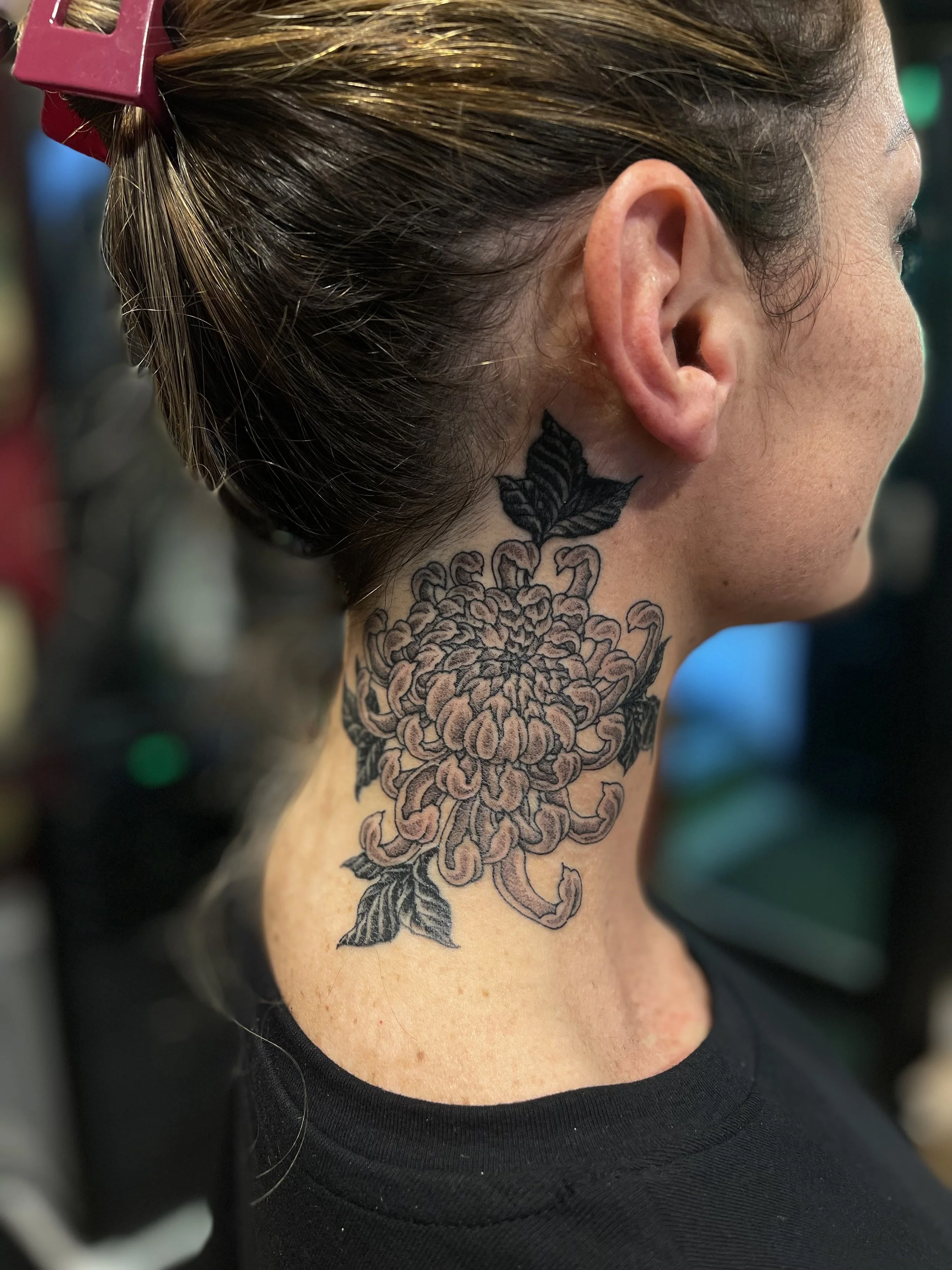 Fine line, black and grey chrysanthemum tattoo on the other side of the neck, done at Frith Street Tattoos, Soho, central London.