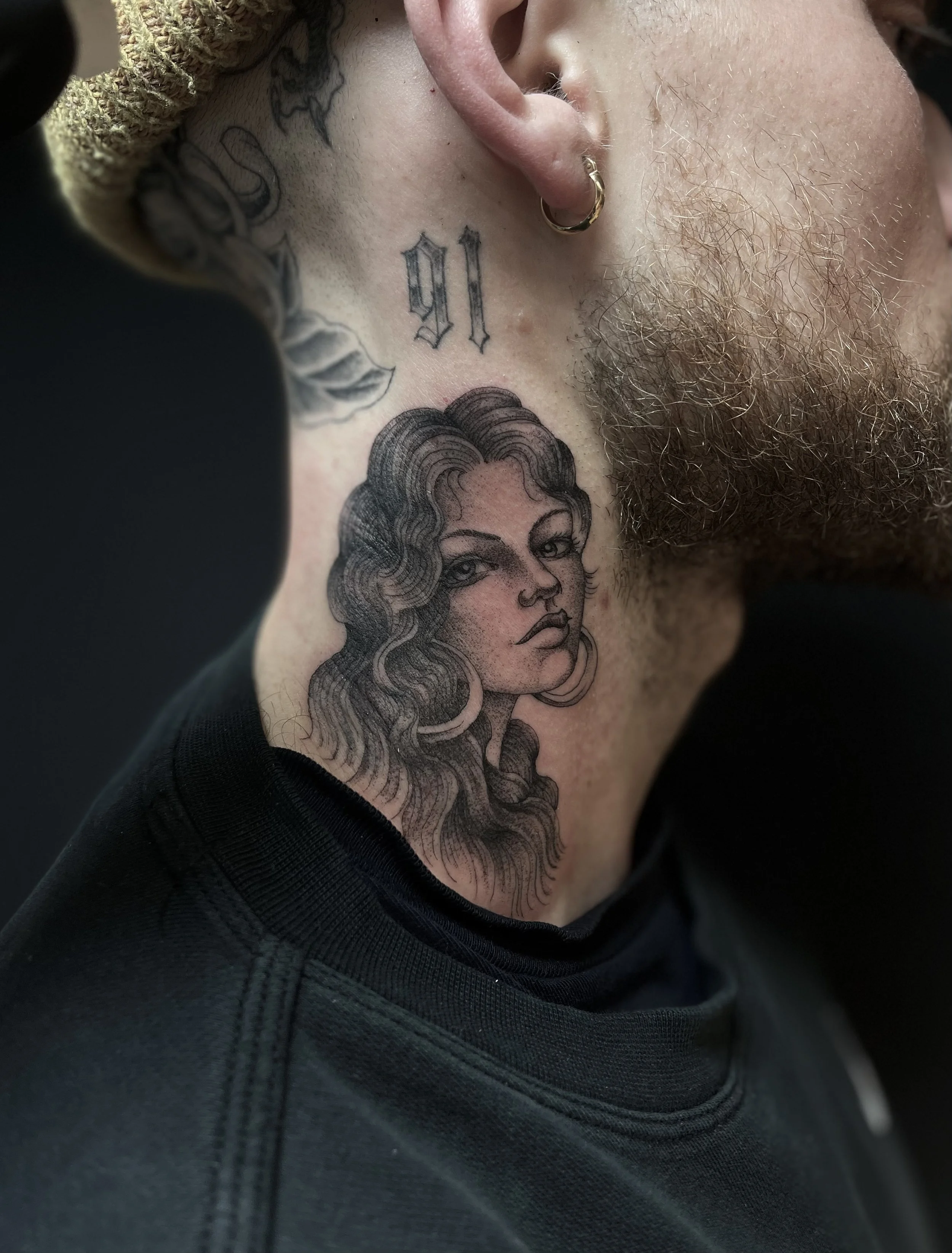 Fine line, single needle girl head tattoo on the neck, done at Frith Street Tattoos, Soho, central London.