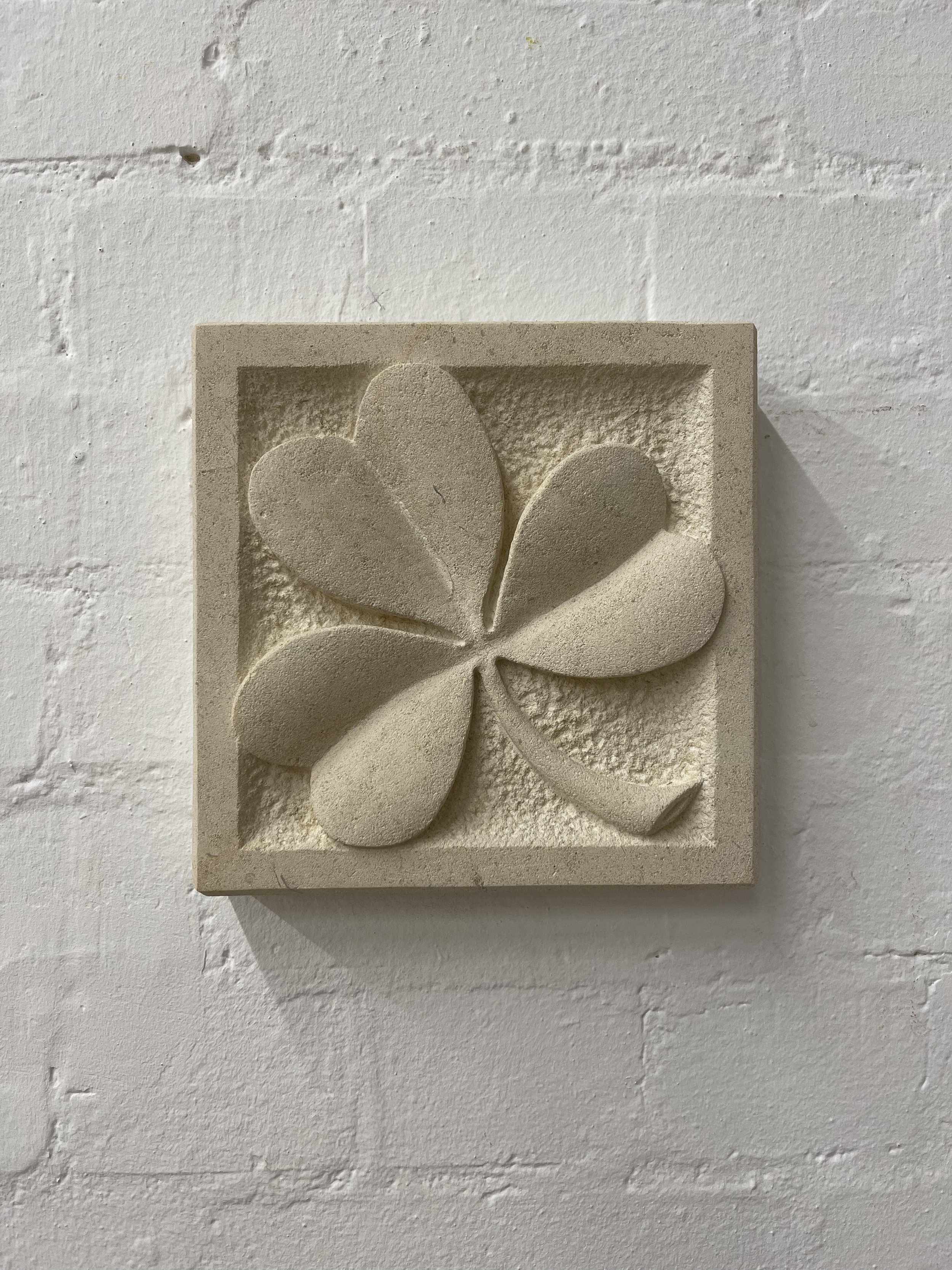 Stone carving of a clover or shamrock, in Caen limestone.