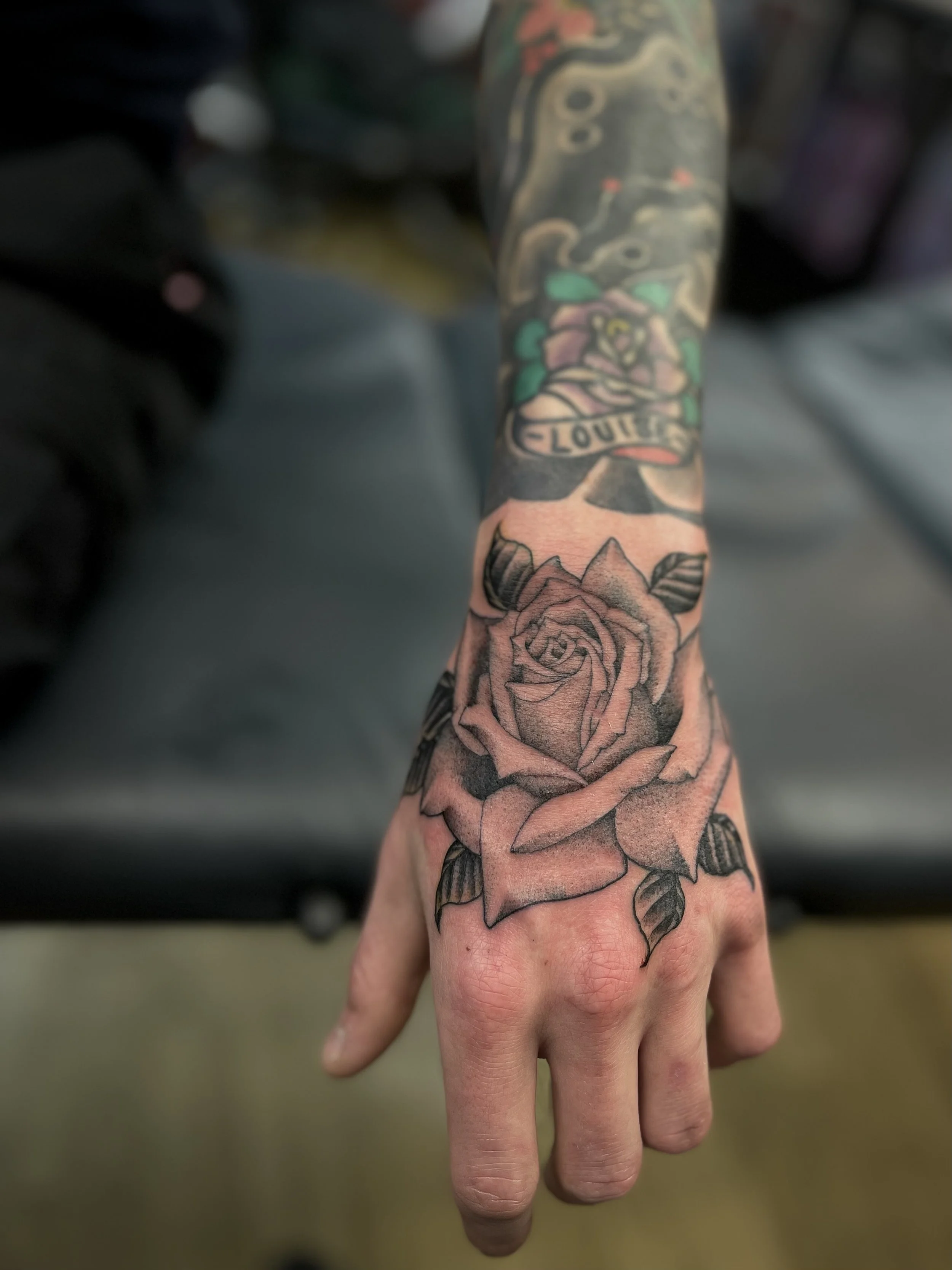 Single needle rose tattoo on the hand, done at Frith Street Tattoos, Soho, central London.