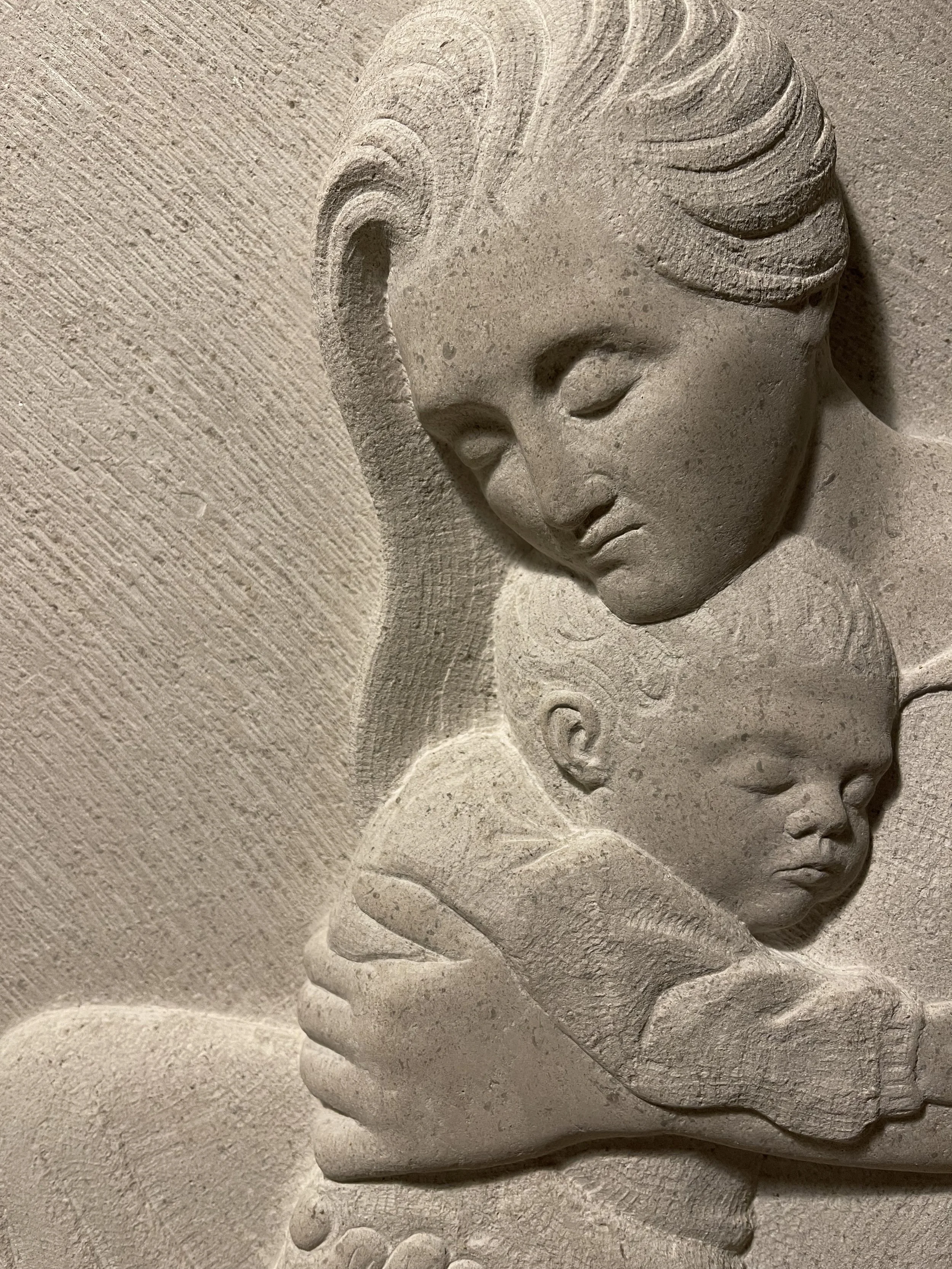 Stone carving in Hopton Wood stone, of a mother and child. Carved in south London.