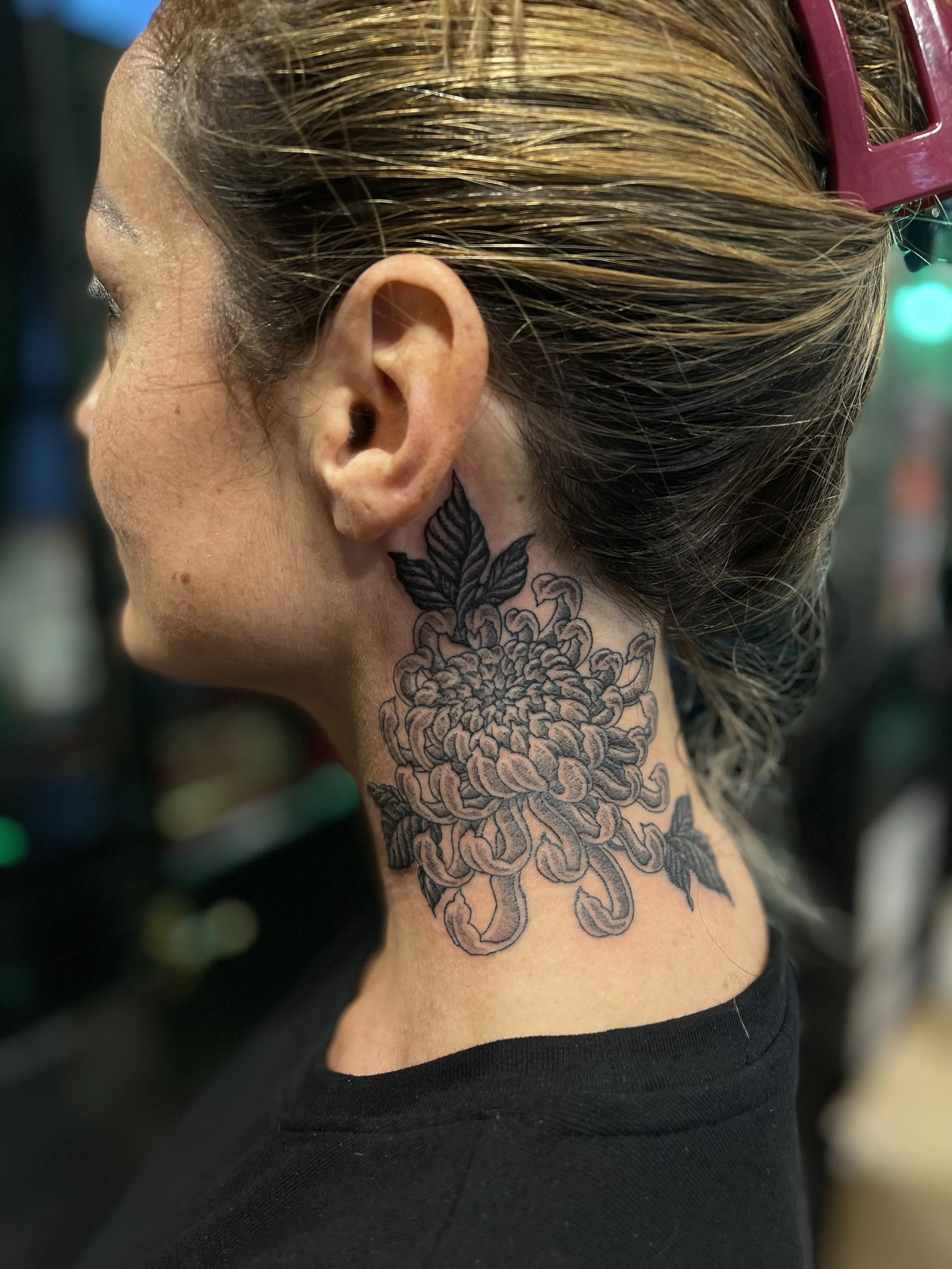 Fine line, black and grey chrysanthemum tattoo on the neck, done at Frith Street Tattoos, Soho, central London.