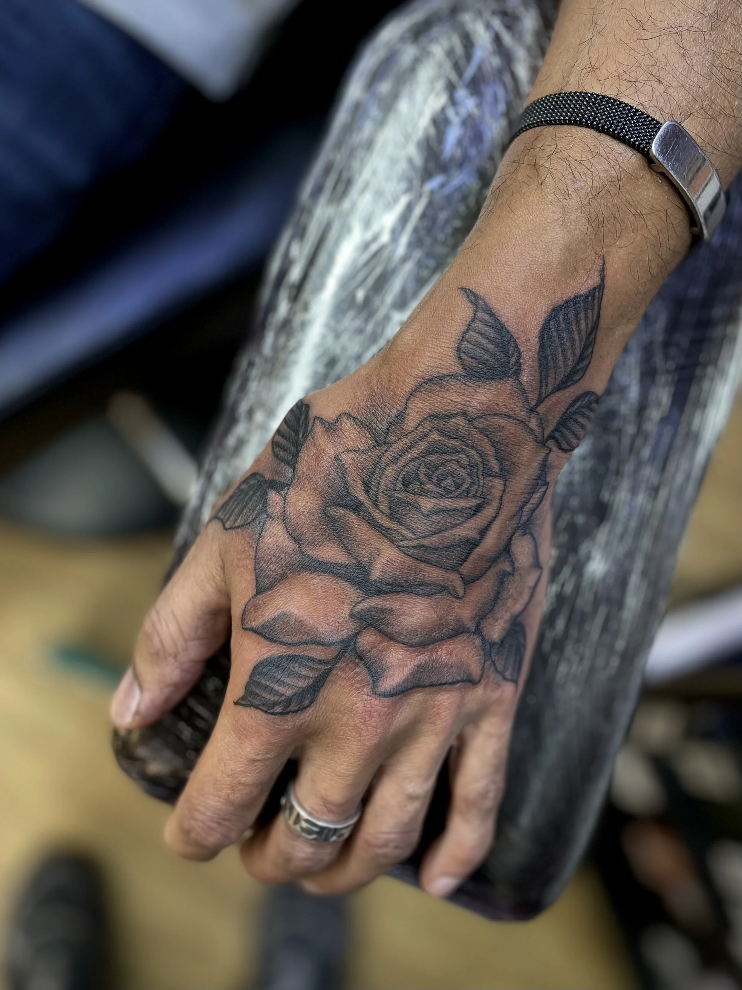 Fine line black and grey rose on the hand done at Frith Street Tattoos, soho, central London.