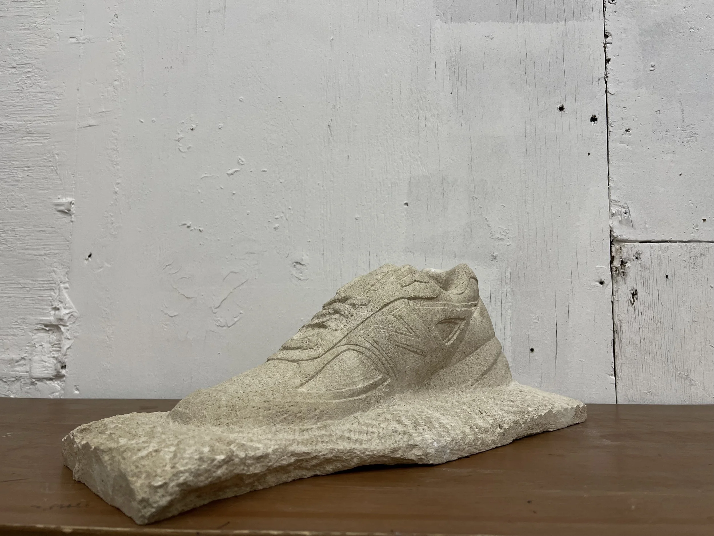 Life-size stone carving of a New Balance trainer, for New Balance at Paris Fashion Week 2026. Carved by hand in West Norwood, south London.