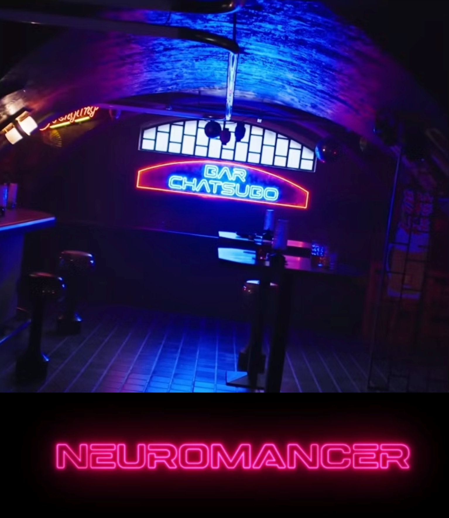 A dimly lit bar with neon signs reading 'BAR CHATSUBO' and 'NEUROMANCER' in pink, with seating and tables visible beneath a dark arched ceiling.