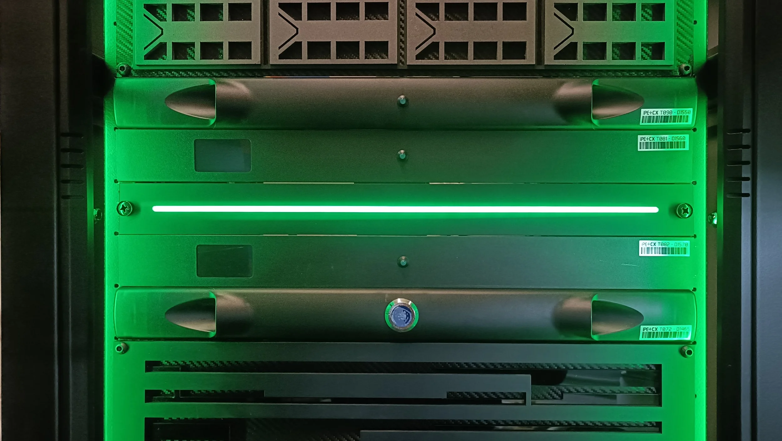 A server rack with green lighting, containing multiple server blades and labels.