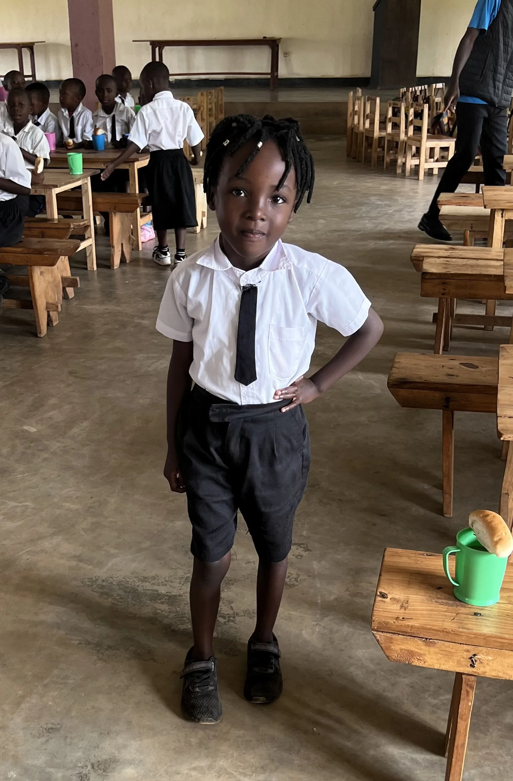 Smiling student in classroom at Cindi's Hope Academy, Rwanda