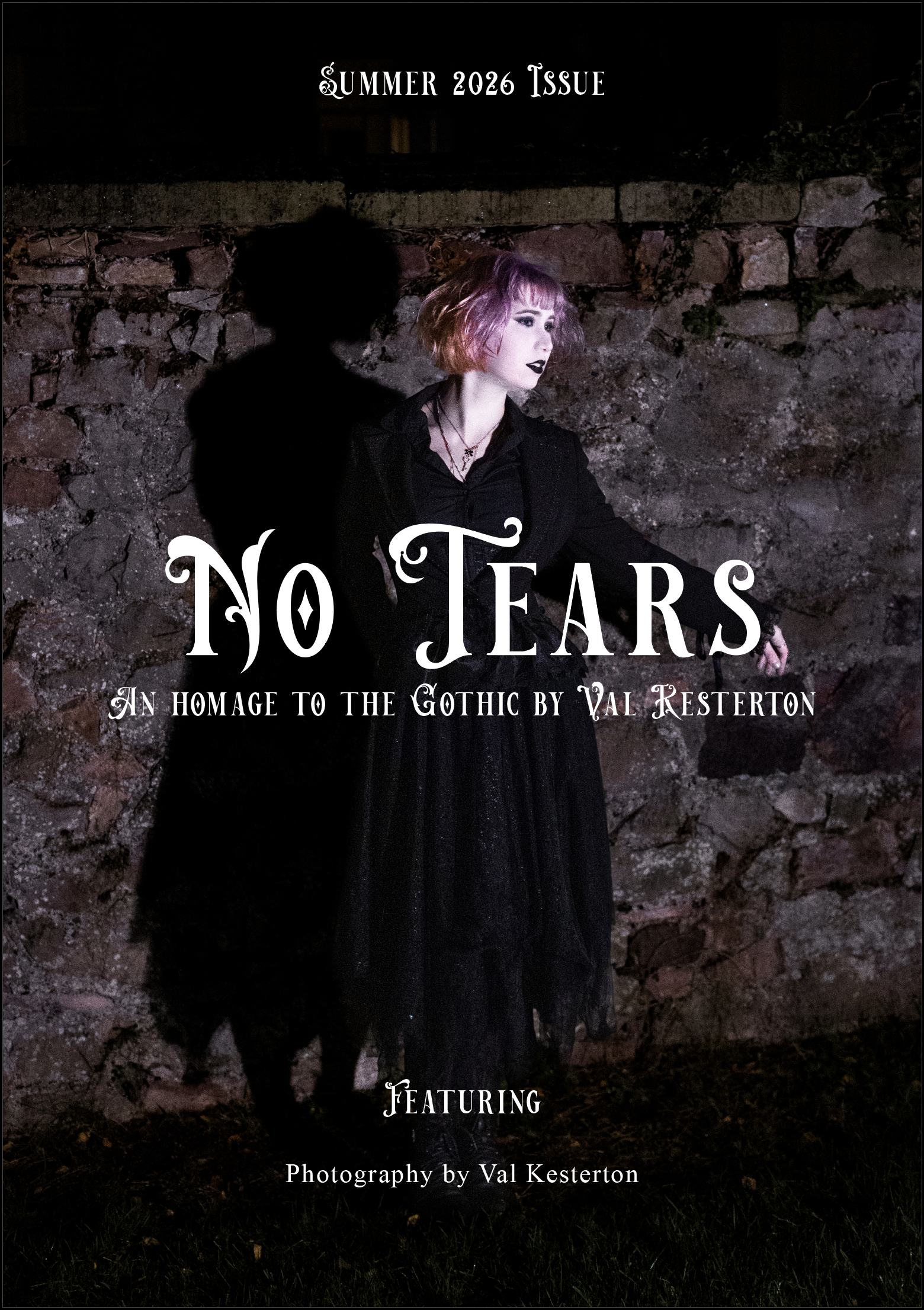 A woman dressed in gothic attire with pink and purple hair, dark makeup, and black lipstick, leaning against a stone wall at night. The image is the cover of a magazine titled 'No Tears,' with text indicating it's the Summer 2026 issue, an homage to Gothic style by Val Kesterton, with photography also by Val Kesterton.