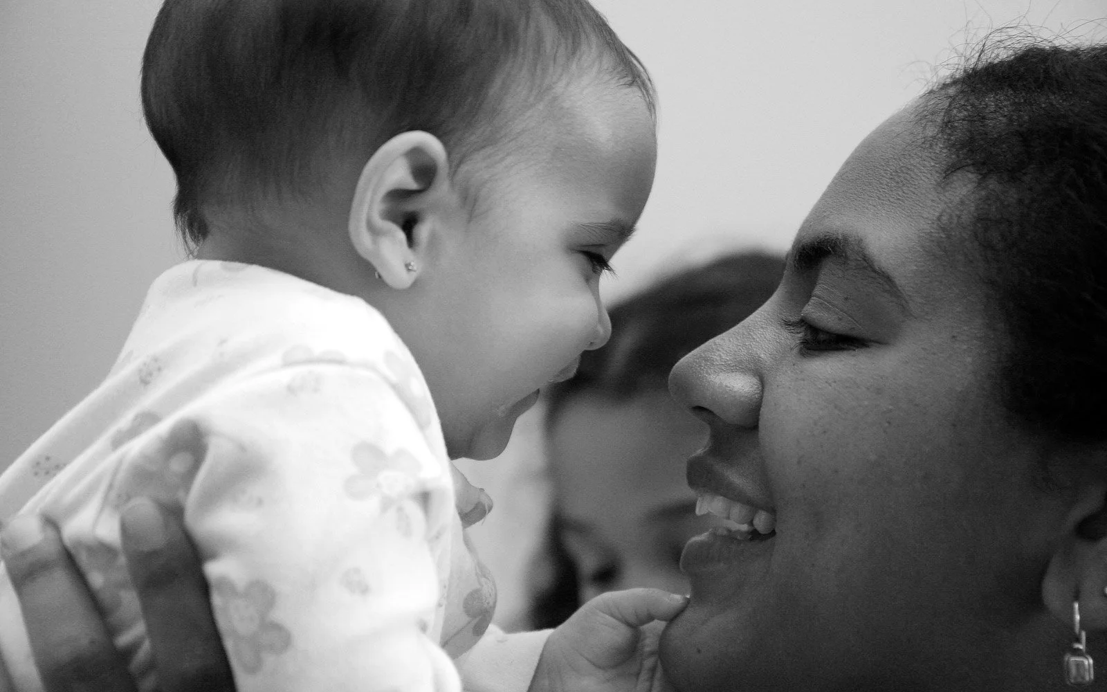 My Ideal Parents - PBSP - A young girl is smiling and looking at a woman with a wide smile, who appears to be her mother, as they touch foreheads and enjoy a close moment.