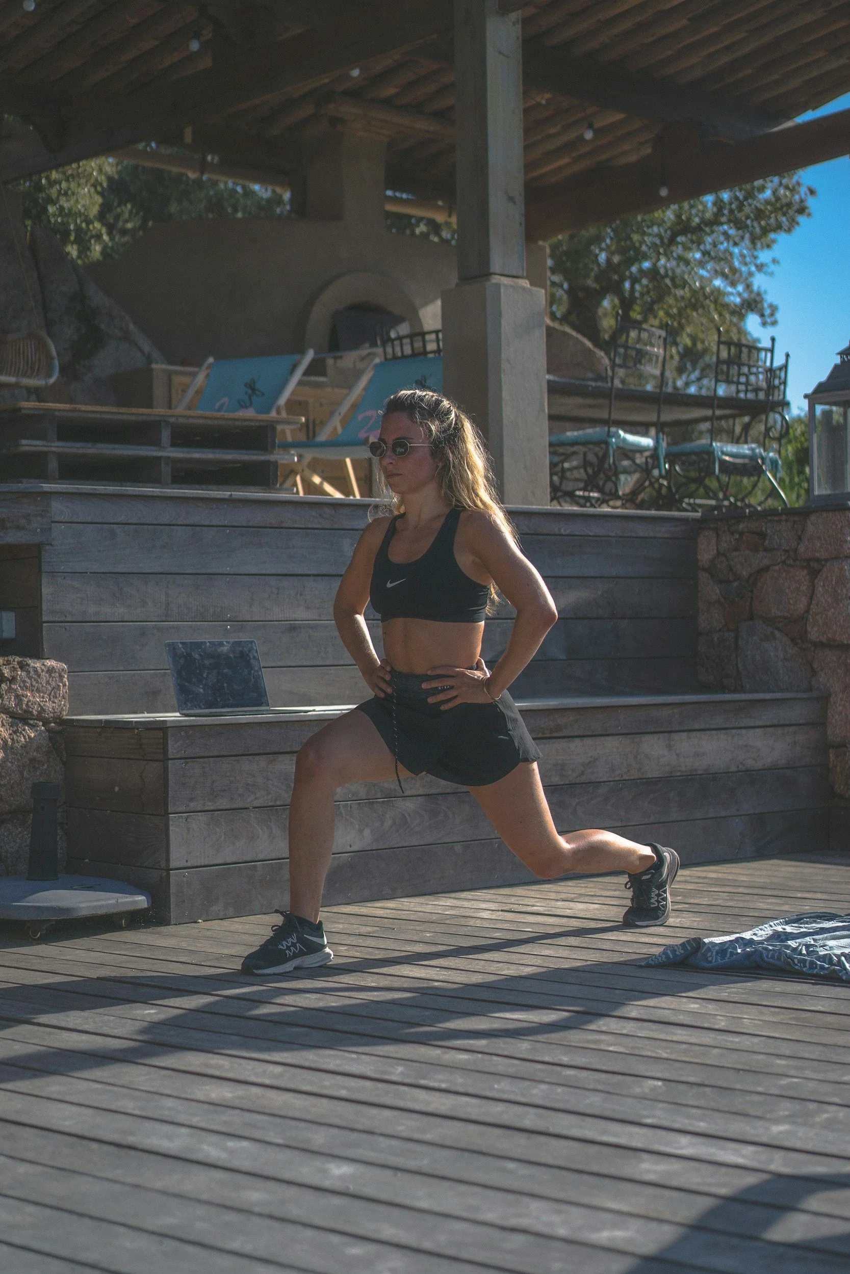 woman performing lunge exercise outdoors