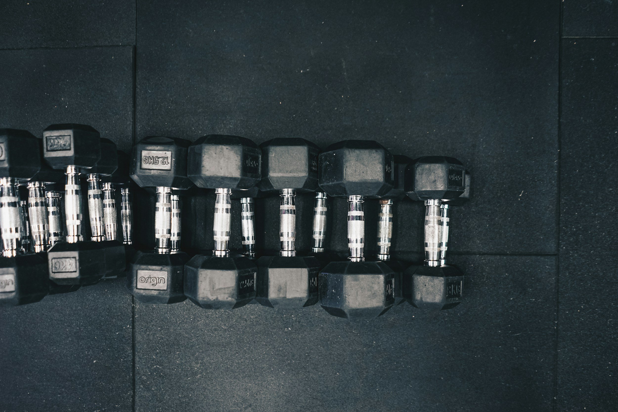 multiple dumbbells piled on top of one another