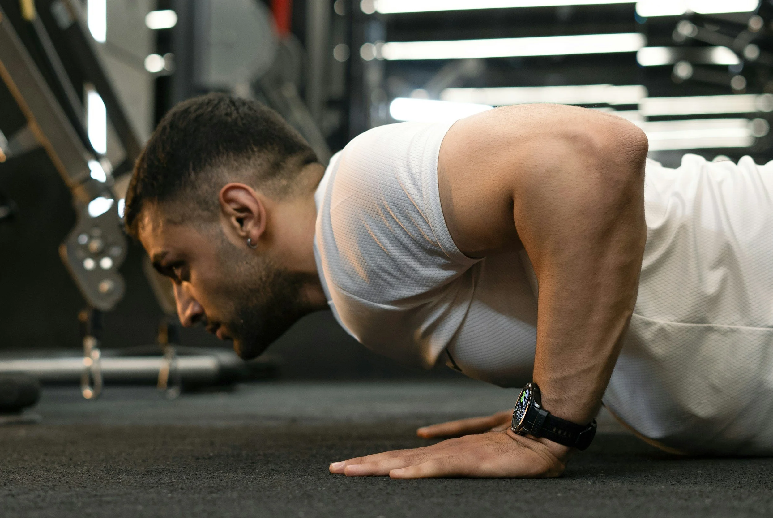 Man performing push-up in gym setting