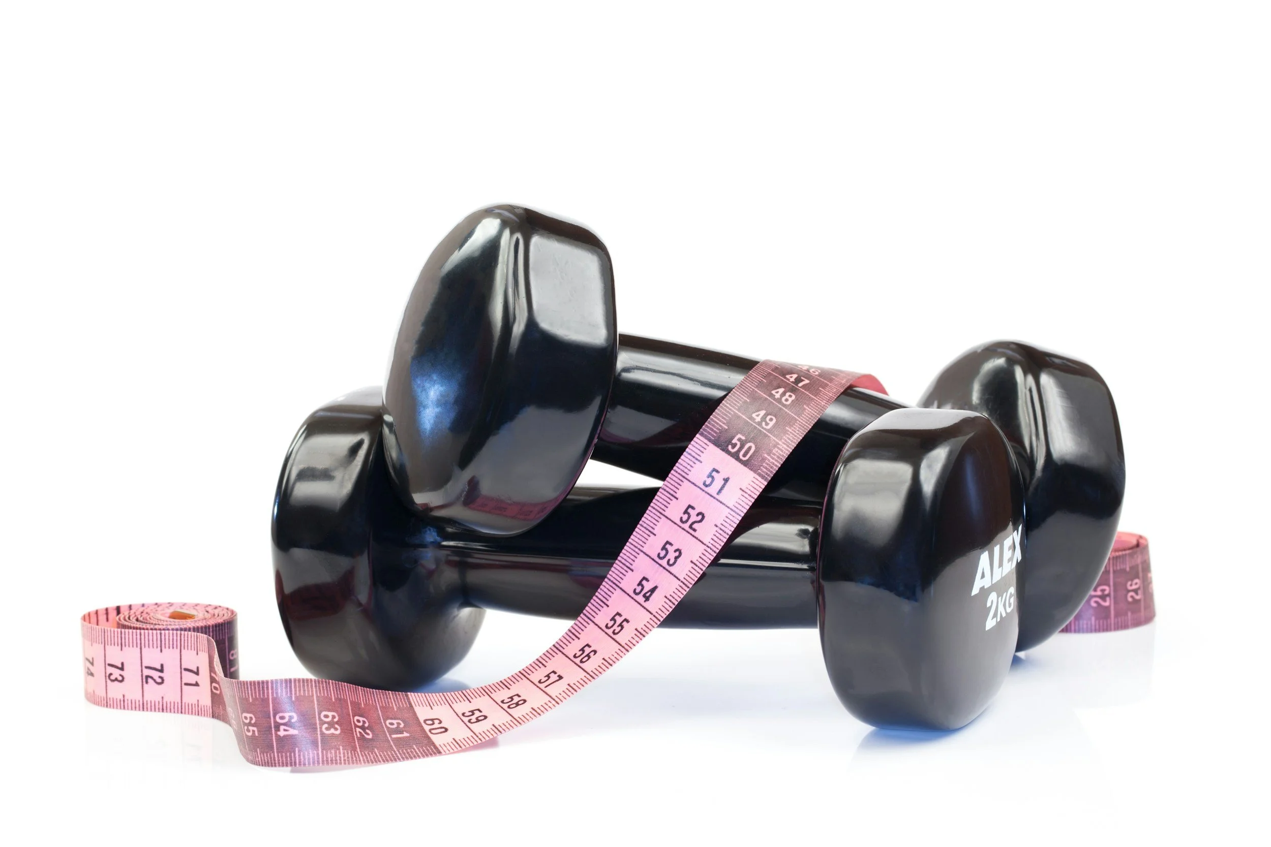 two dumbbells with measuring tape over top of them